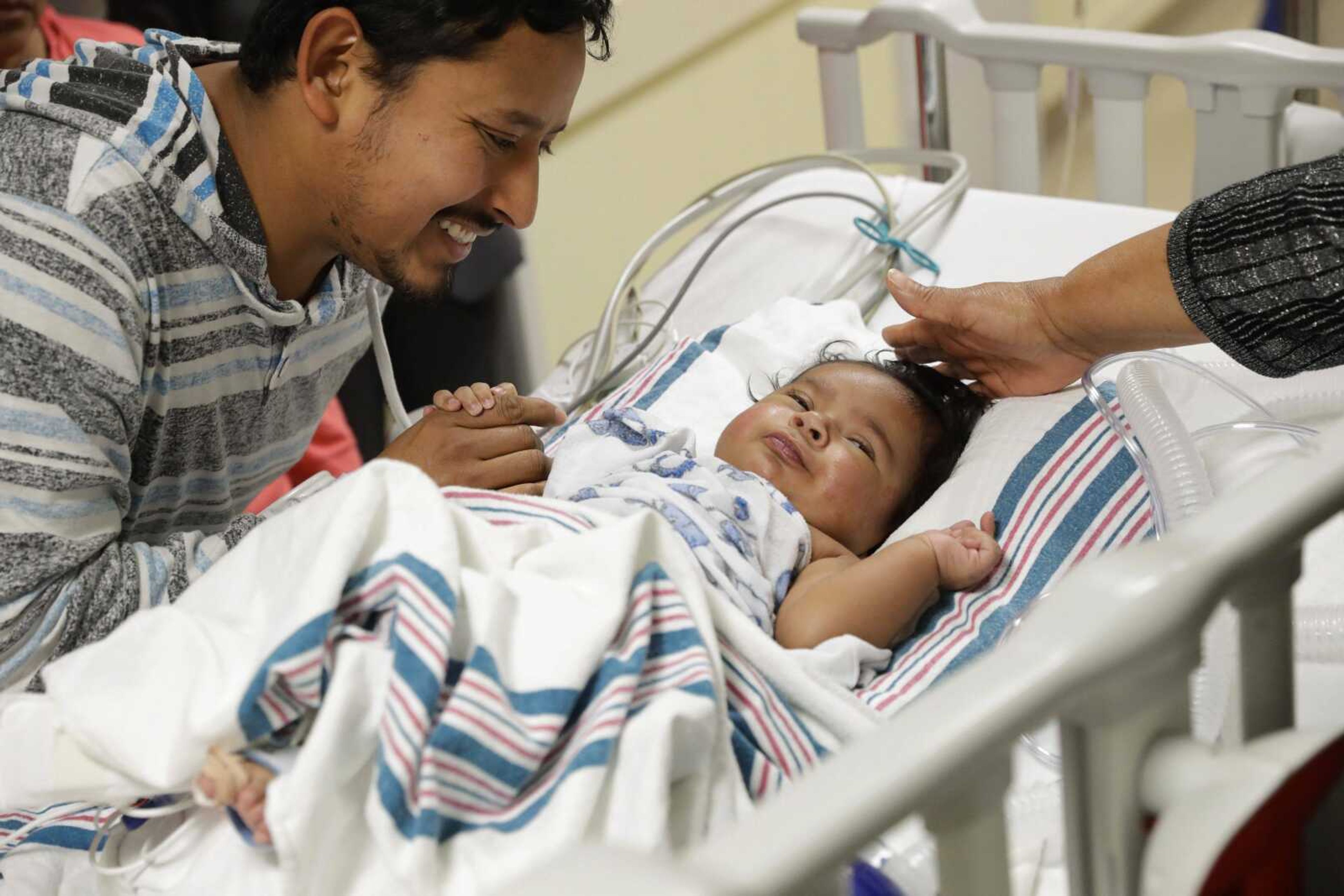 Hidelberto Salinas Ramos, left, says goodbye to his son, Josue Salinas Salgado, before he is wheeled into open-heart surgery Nov. 28 at the University of Maryland Medical Center in Baltimore.