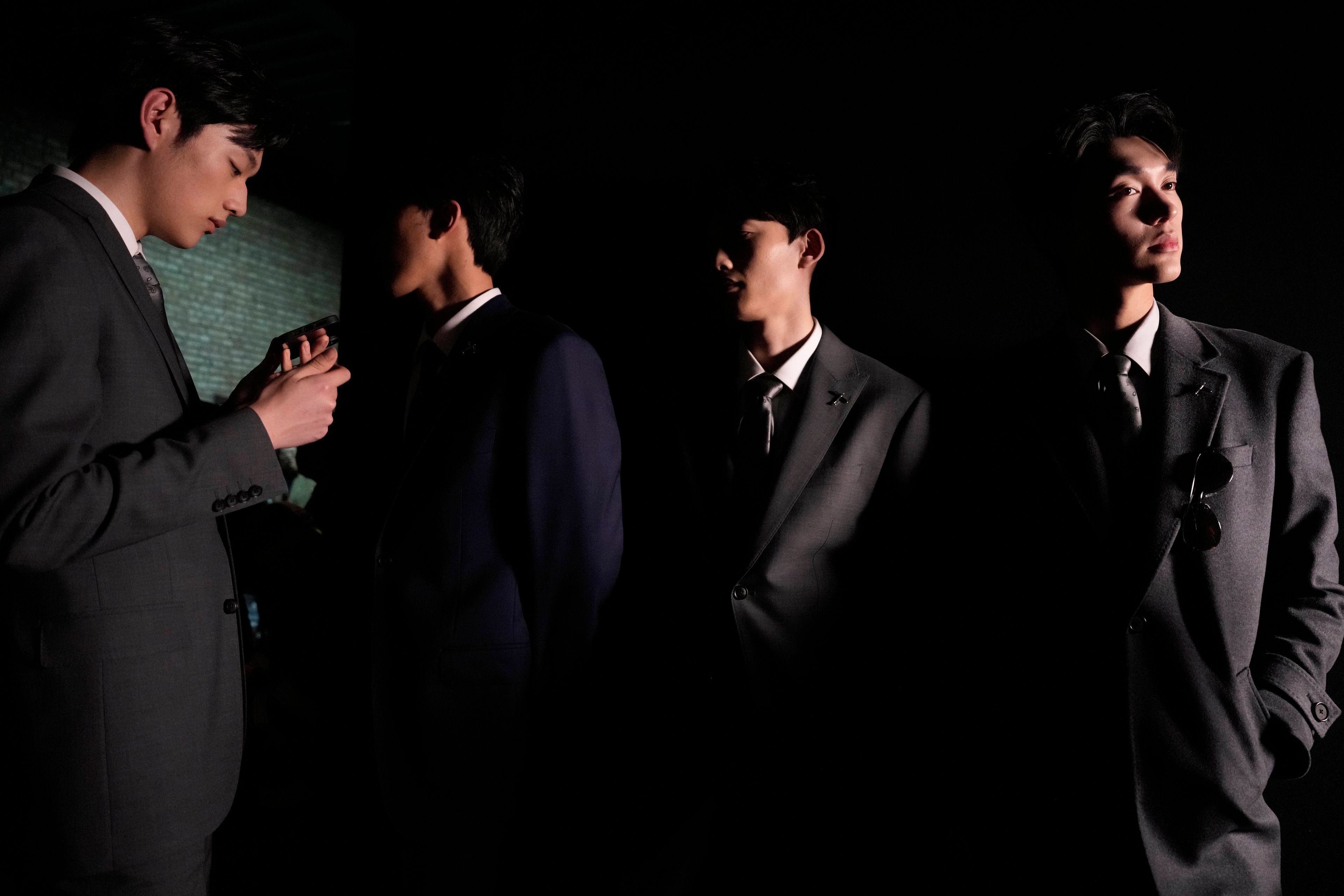 Models wait backstage for a show to start during China Fashion Week in Beijing on March 28, 2024. (AP Photo/Ng Han Guan)