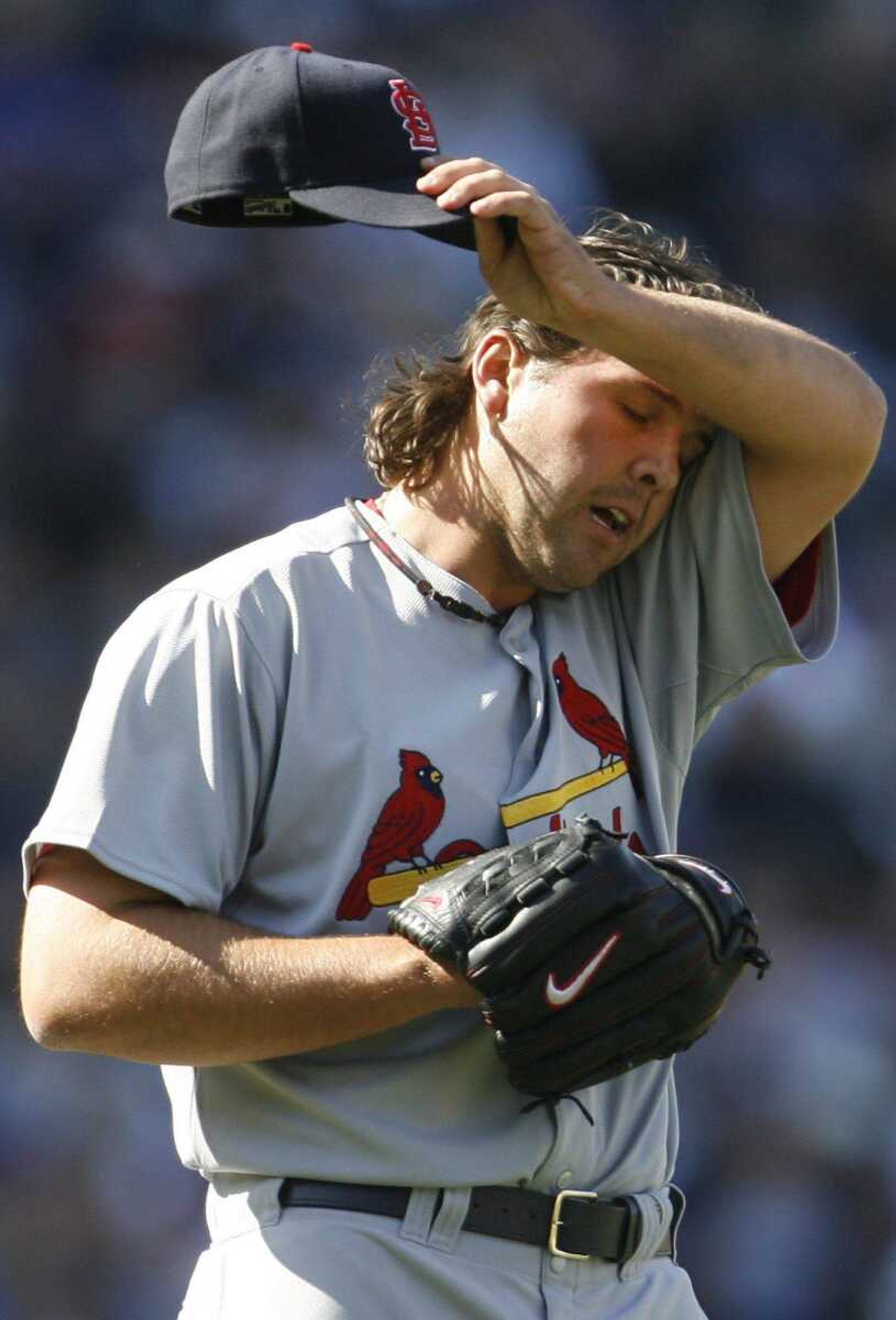 Cardinals relief pitcher Chris Perez wipes his face during the eighth inning Friday in Chicago. Perez yielded a two-run home run to the Cubs' Alfonso Soriano in the inning and took the loss. (NAM Y. HUH  Associated Press)