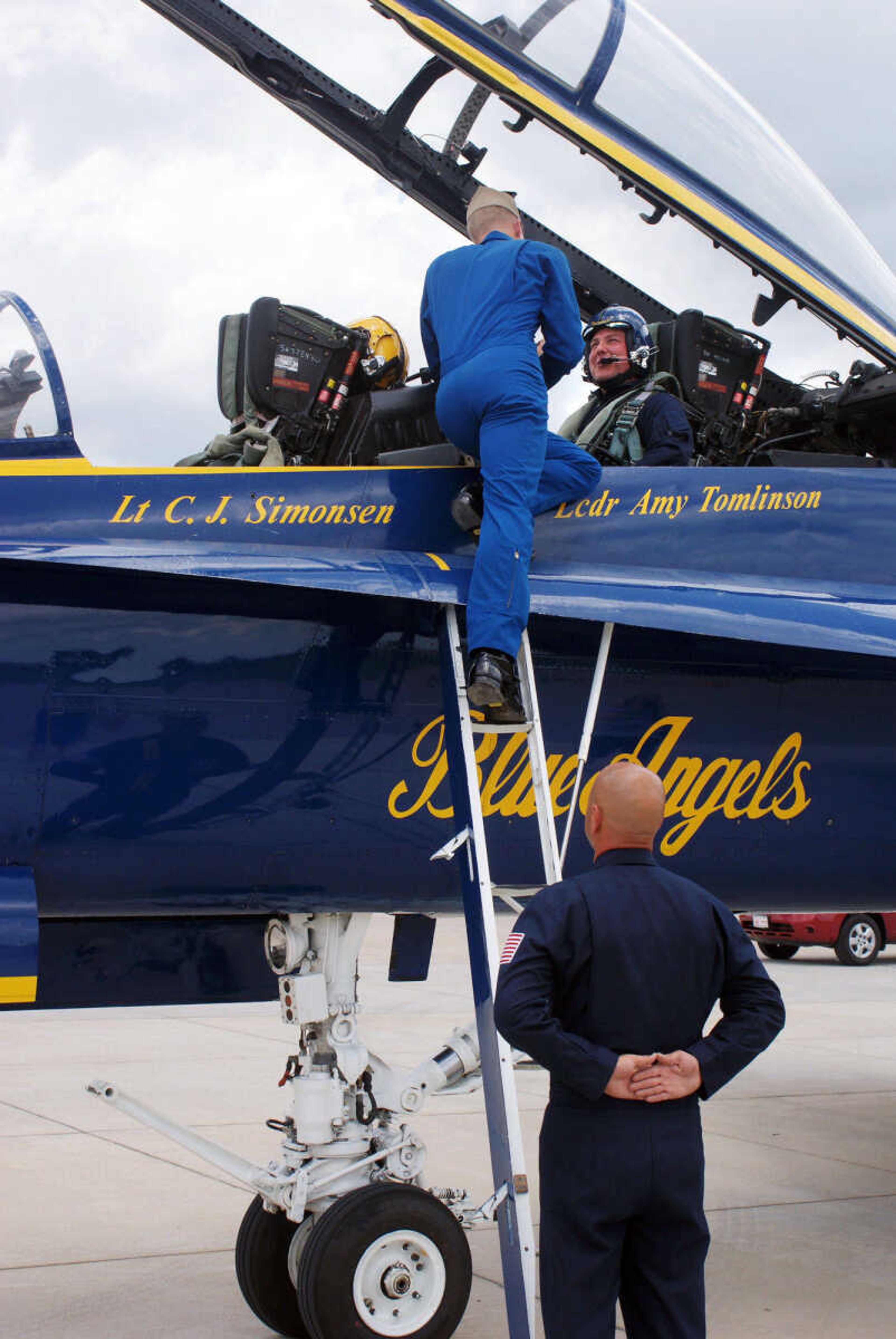 BAILEY REUTZEL ~ breutzel@semissourian.com

Rob Bunger, right, gets strapped into the F/A-18 plane flown by Blue Angel pilot Lt. C.J. Simonsen, left, as #7 Crew Chief Chad Swanson, bottom, stands by at the Cape Girardeau Airport on Wednesday, June 16, 2010. Bunger was one of three area people who got the chance to fly with the Blue Angels on Wednesday.