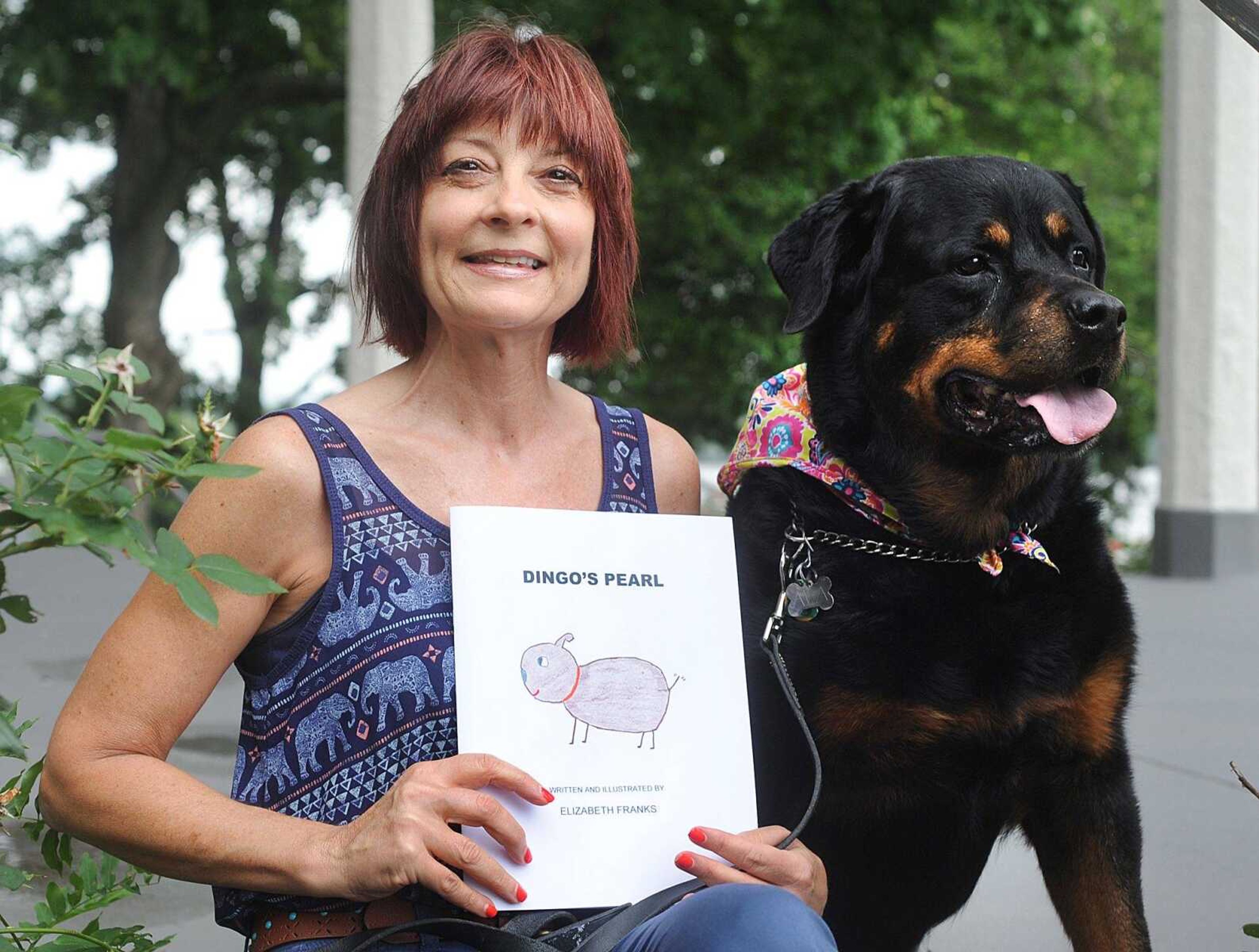 Elizabeth Franks, author of "Dingo's Pearl", poses with her Rottweiler, Ava, on the lawn of the Common Pleas Courthouse on Wednesday in Cape Girardeau. (Laura Simon)