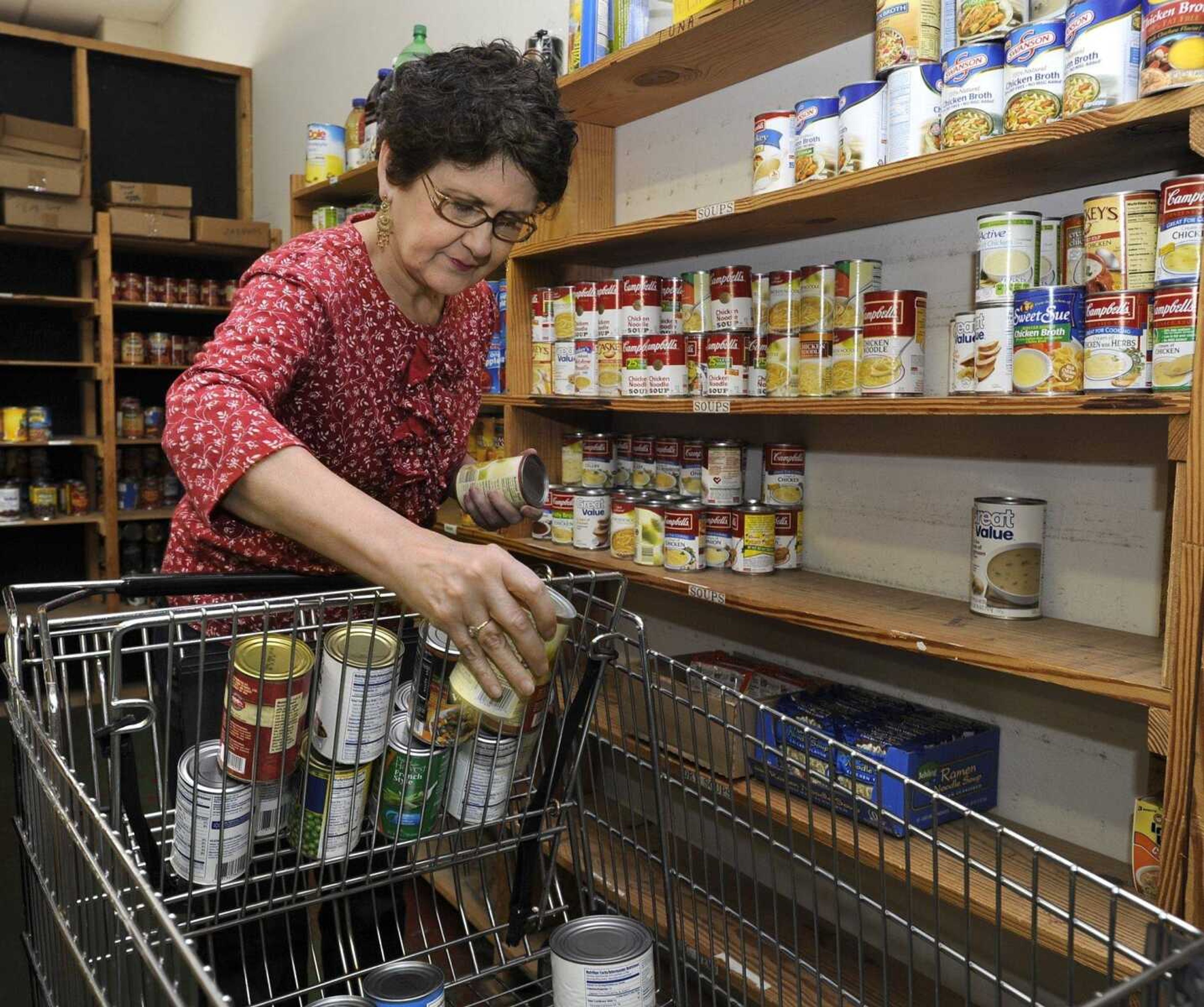 Jeanne Hirsch, one of the FISH volunteers of Cape Girardeau, fills a food order at the pantry. The organization helps feed people who have fallen on hard times. (Fred Lynch)