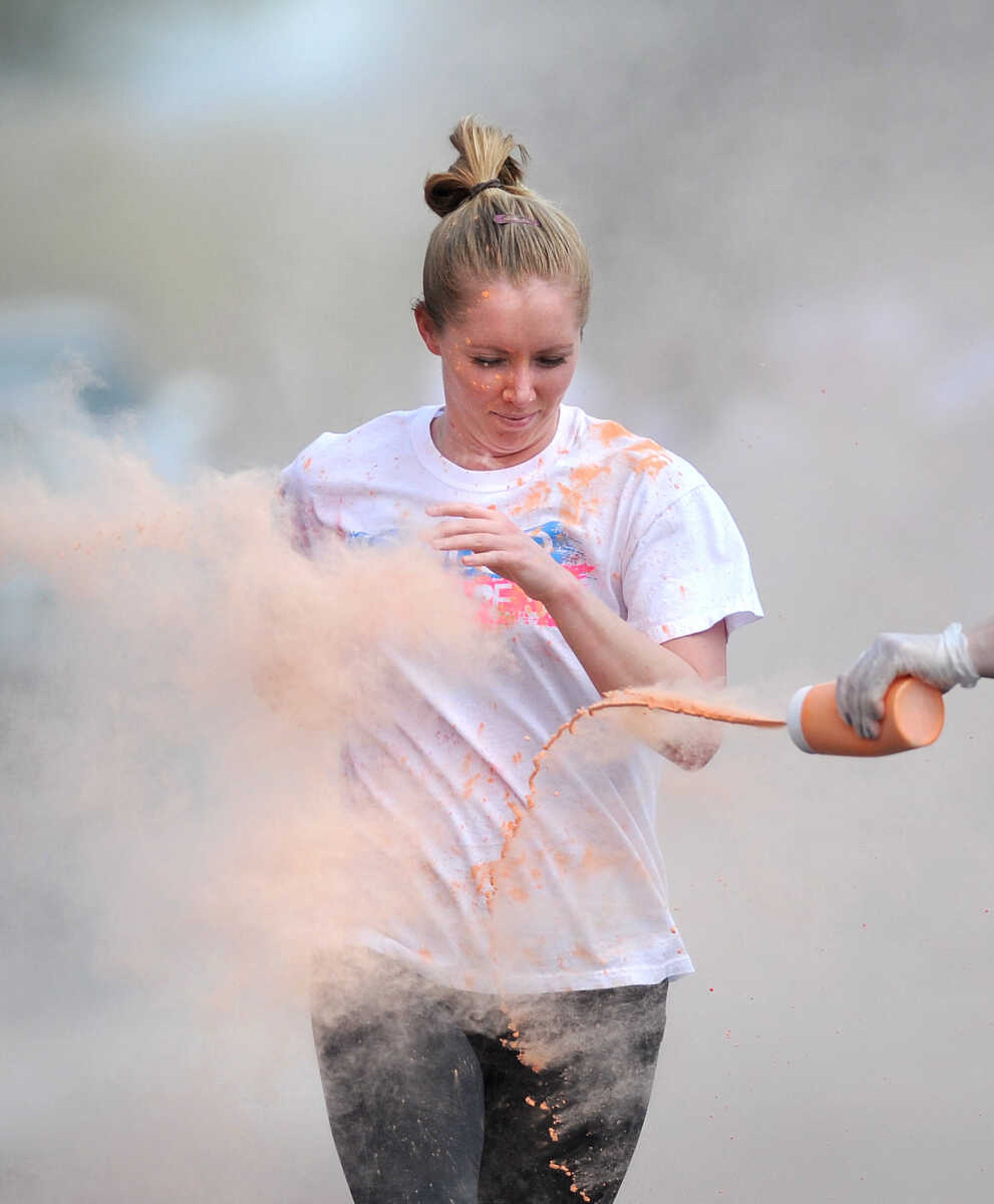 LAURA SIMON ~ lsimon@semissourian.com

Participants in the Color Me Cape 5K are sprayed with orange powder at the first color station on Good Hope Street, Saturday, April 12, 2014, in Cape Girardeau.