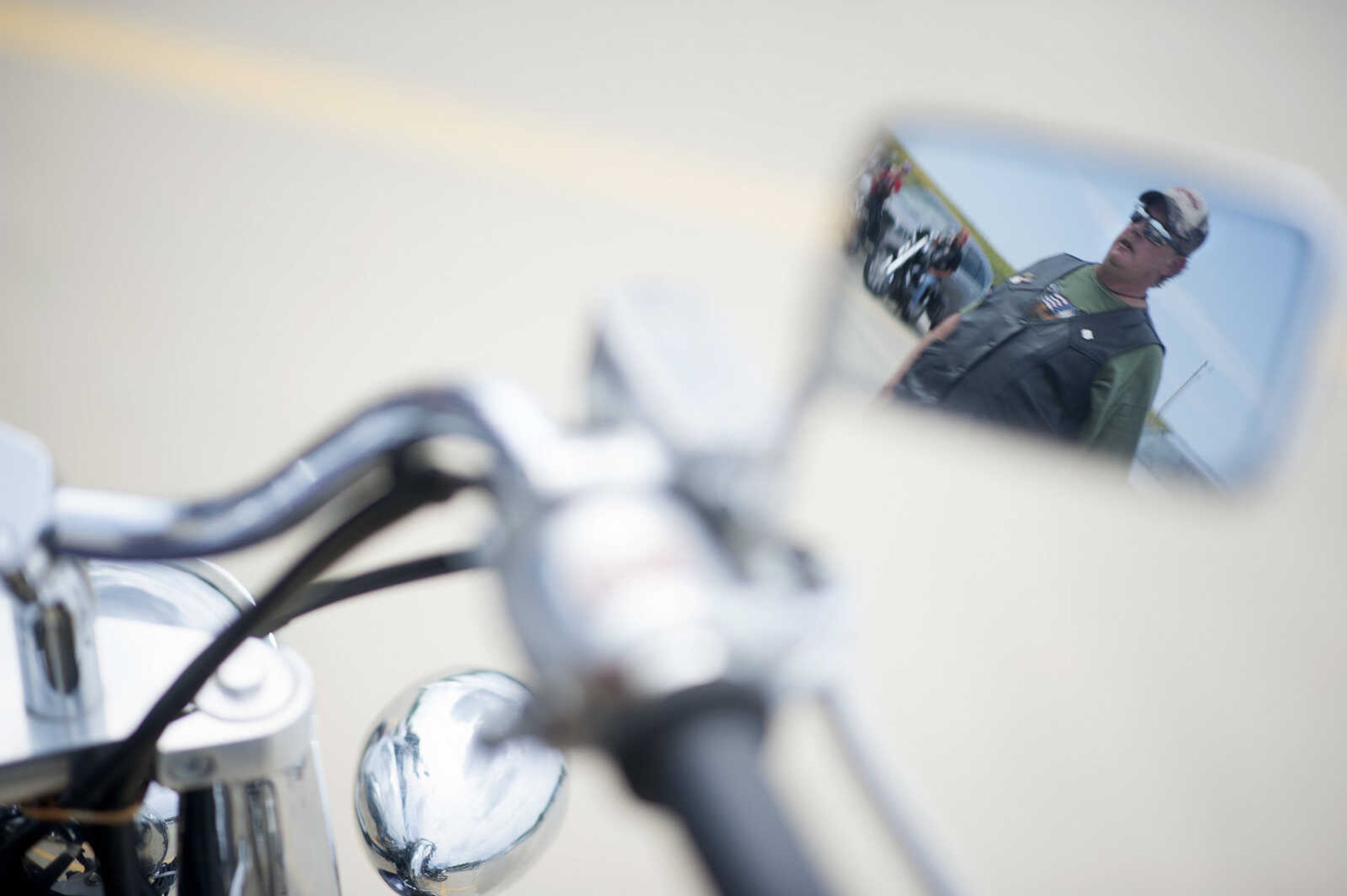 George LaGois is seen reflected in a motorcycle mirror during the first-ever Missouri Vietnam Wall Run  Thursday, Sept. 12, 2019, at the Missouri's National Veterans Memorial in Perryville.