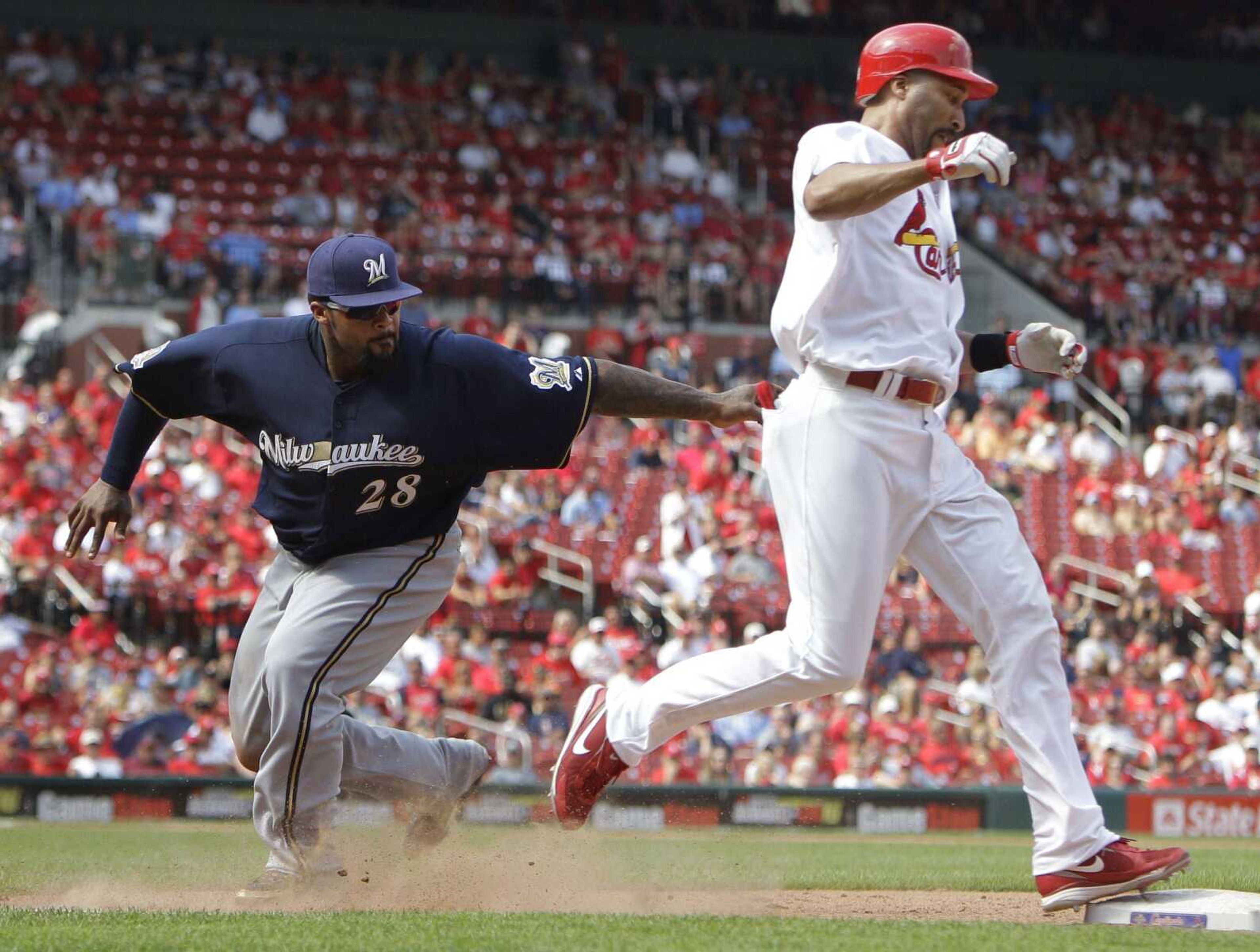 St. Louis Cardinals' Randy Winn, right, is tagged out by Milwaukee Brewers first baseman Prince Fielder before reaching first base during the ninth inning of a baseball game Wednesday, Aug. 18, 2010, in St. Louis. The Brewers won 3-2. (AP Photo/Jeff Roberson)