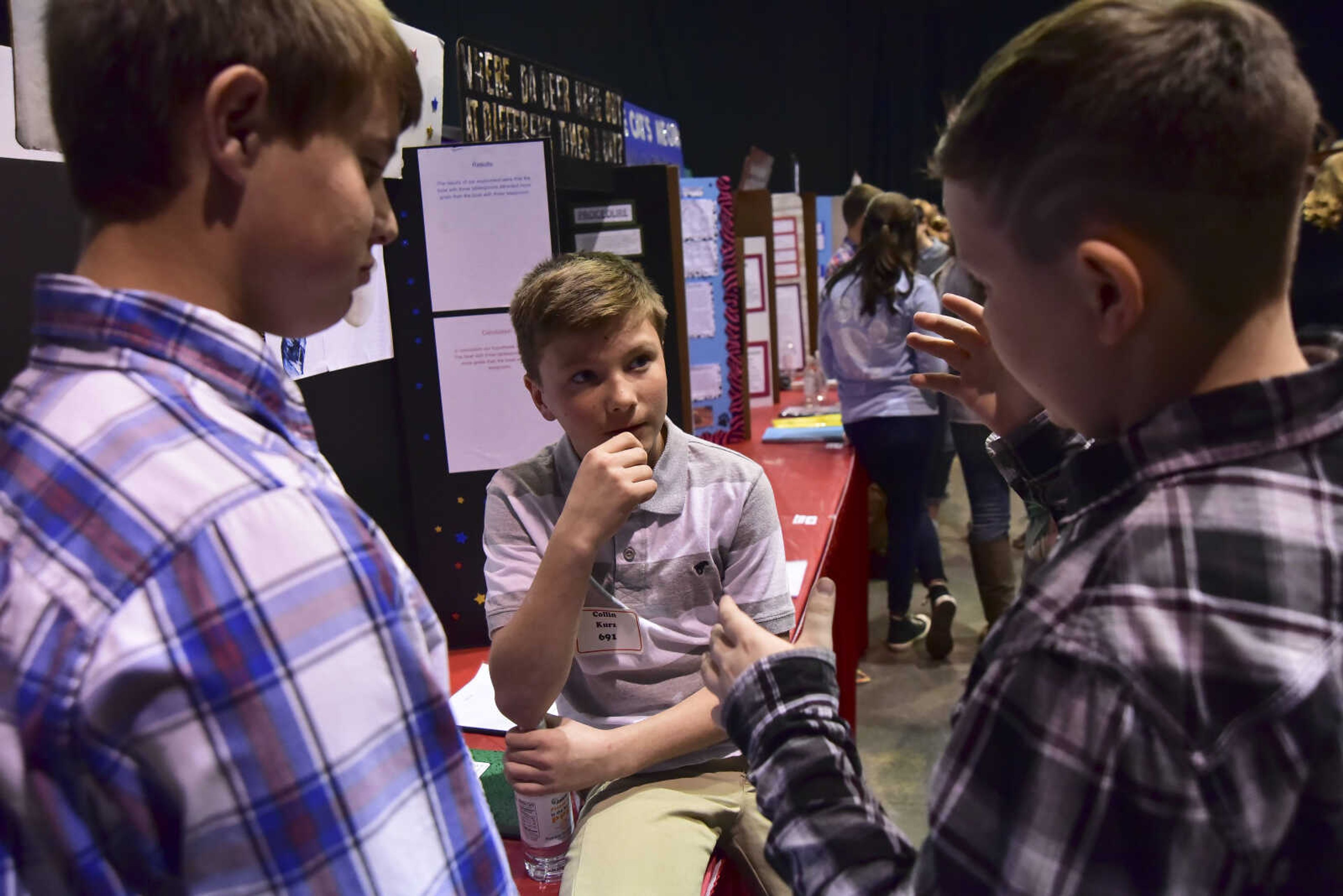 From left, Lane Hover, Collin Kurz and Jacob Harris talk to each other during the Southeast Missouri Regional Science Fair Tuesday, March 7, 2017 at the Show Me Center in Cape Girardeau.