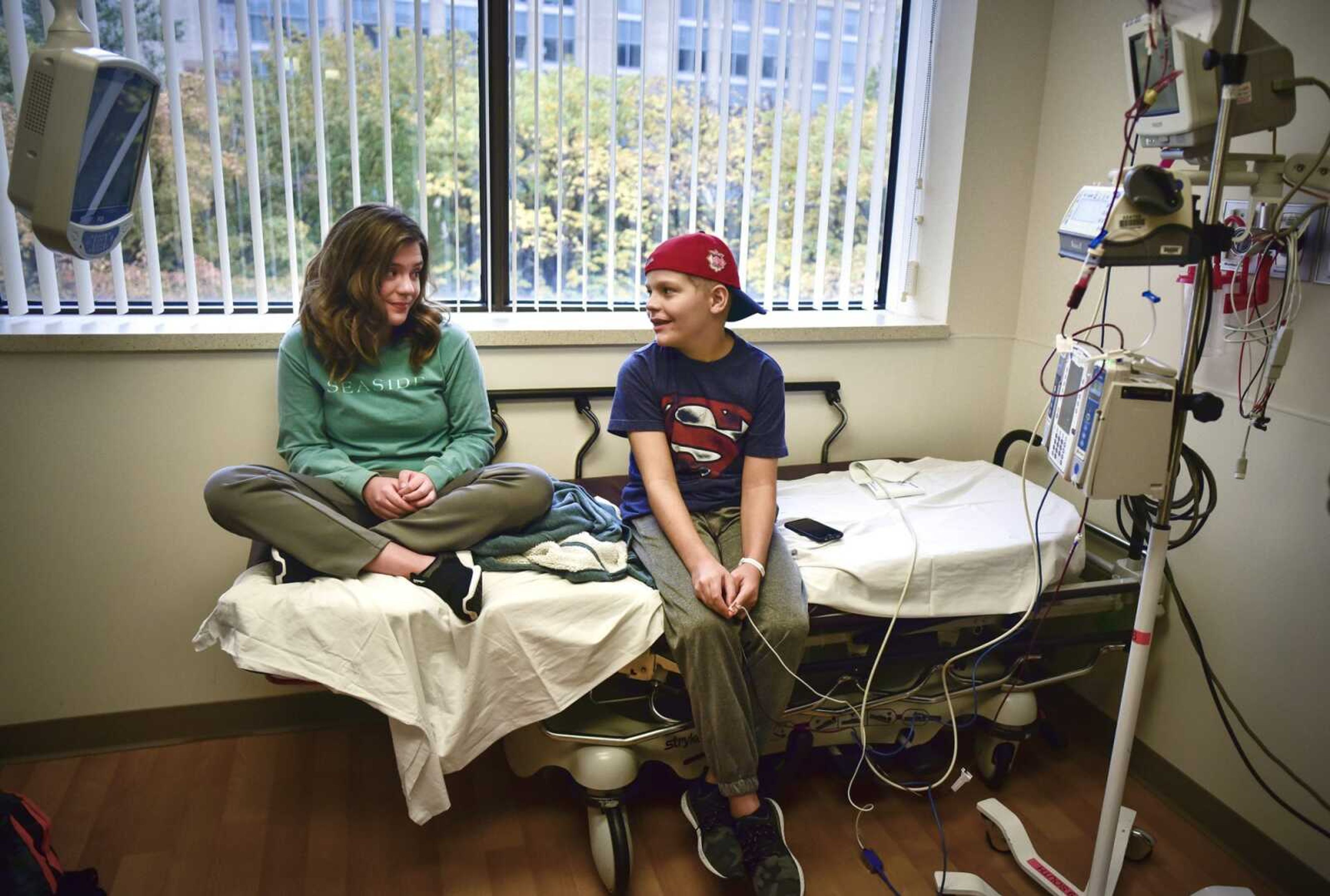 Allee McKee exchanges a glance with her 11-year-old twin brother Matthew as he receives a blood transfusion Oct. 29 at St. Louis Children's Hospital.