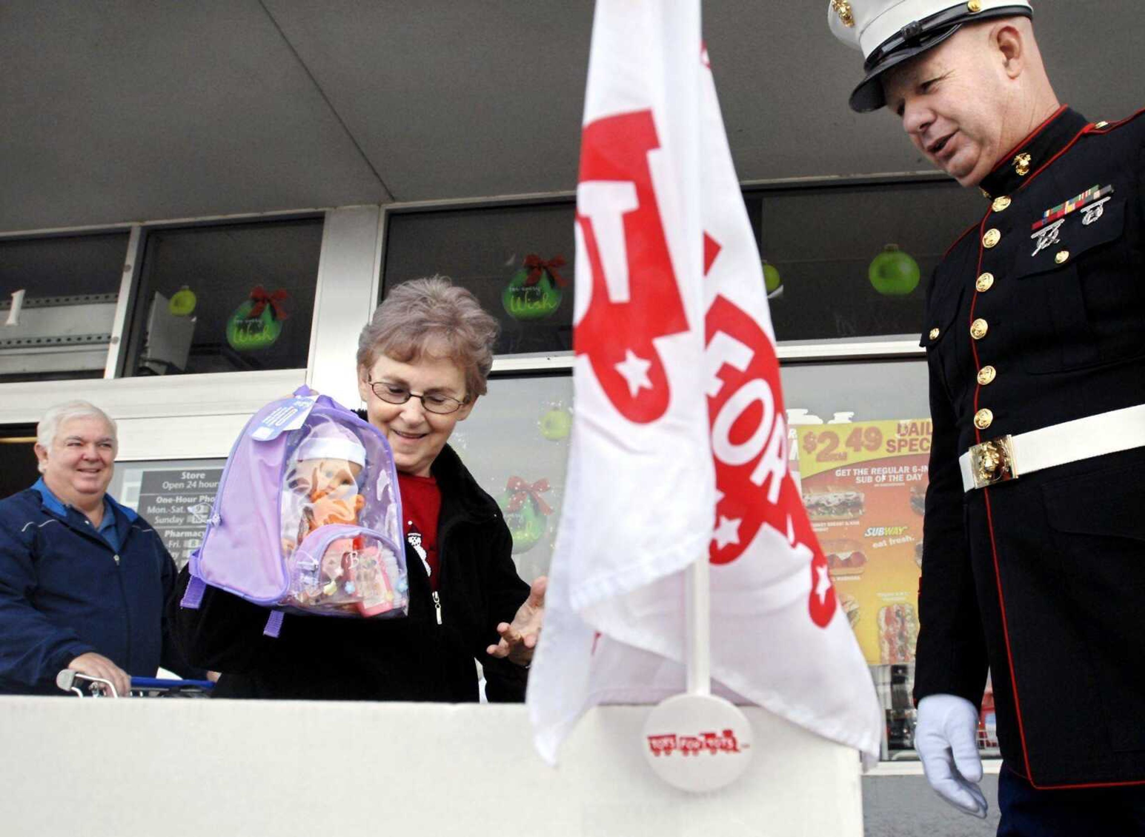 Frances Baker, left, added a doll to the Marine Corps Reserve Toys for Tots donation box Friday outside the Jackson Wal-Mart as Elmer Mansfield thanked her. (Kit Doyle)