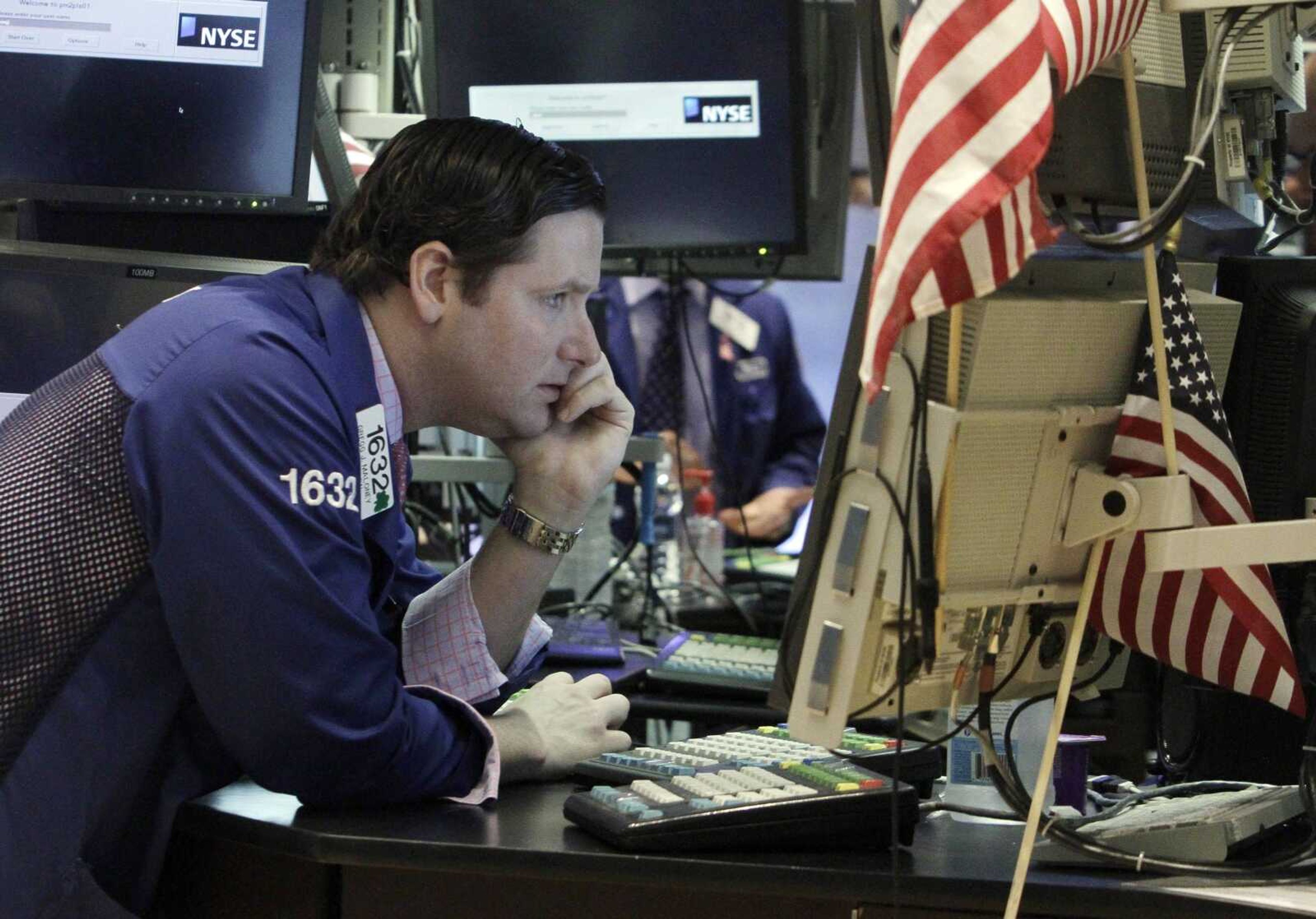 Specialist Gregg Maloney works Thursday at his post on the floor of the New York Stock Exchange. (Richard Drew ~ Associated Press)