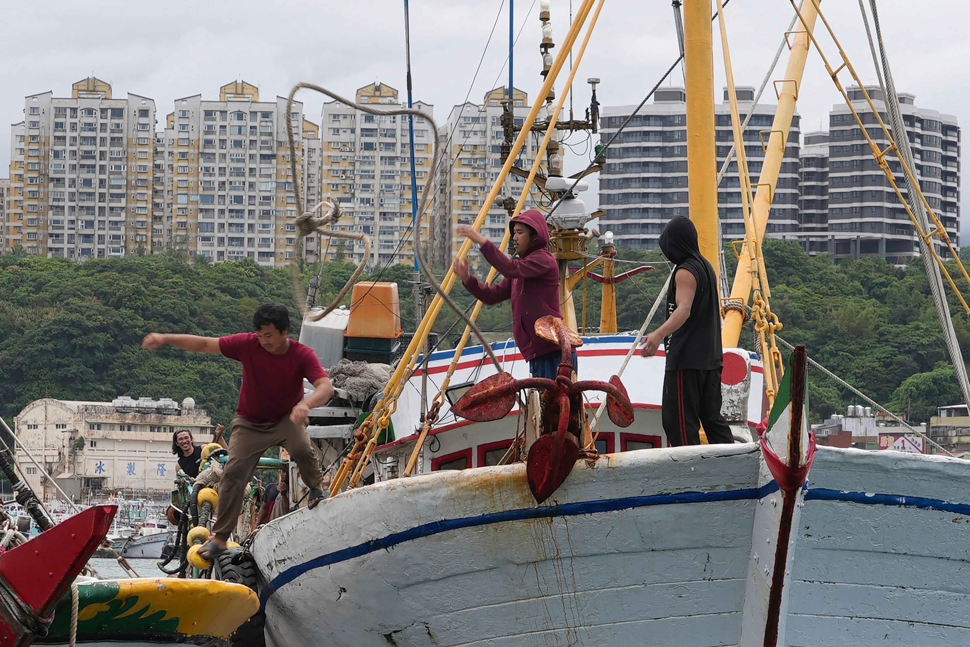 Workers tighten boats with ropes before Typhoon Krathon arrives, at a harbor in Keelung, Taiwan, Monday, Sept. 30, 2024. (AP Photo/Johnson Lai)