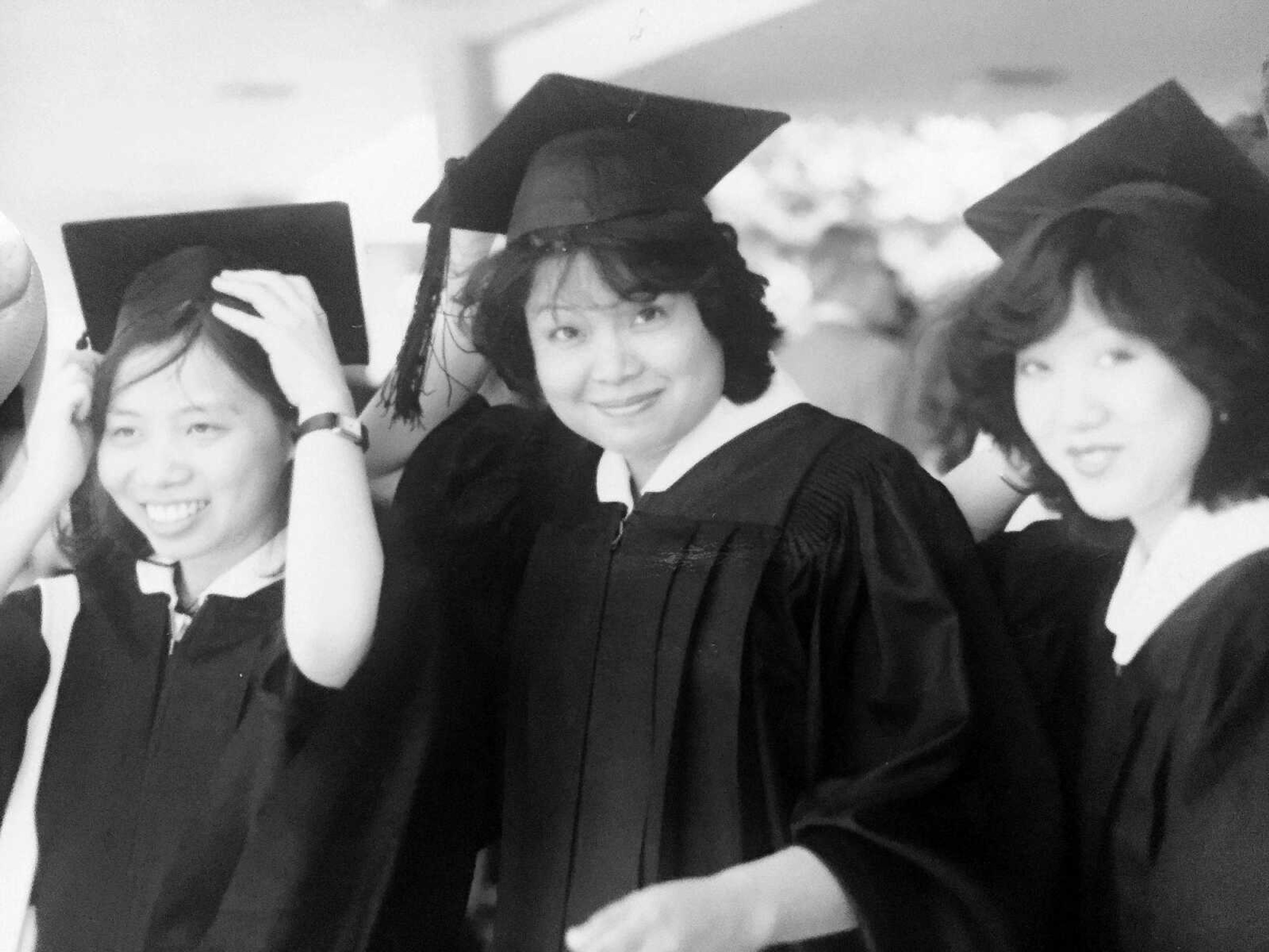 Su (middle) stands between two of her college friends while graduating from Memphis State, a path spread by many of her siblings.