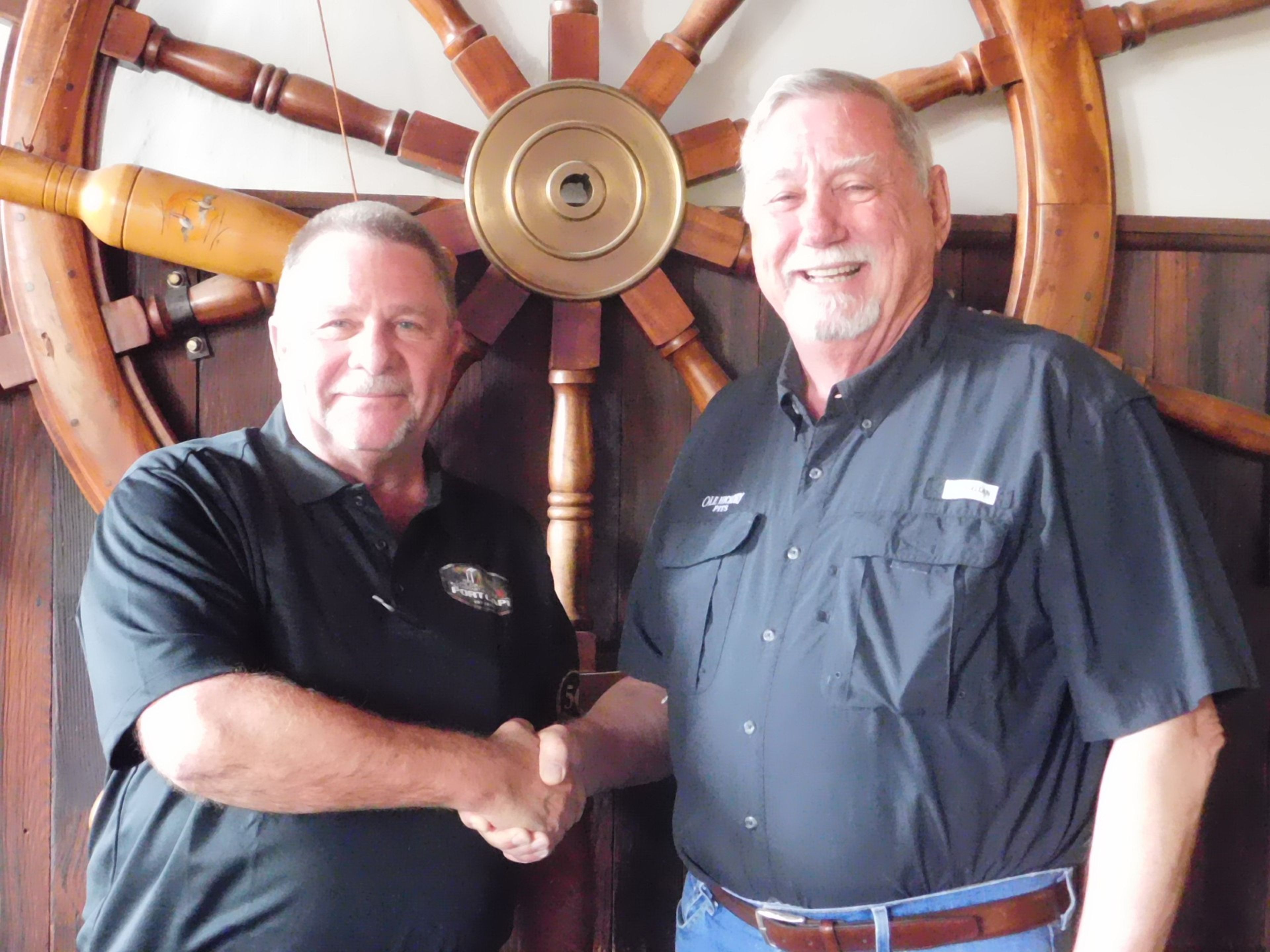 Dennis "Doc" Cain, left, shakes hands with David B. Knight at Port Cape Girardeau Restaurant and Lounge in downtown Cape Girardeau. Knight opened the establishment in 1974 and Cain purchased it from him in 1988. It is one of the oldest restaurants in Cape Girardeau, and Cain is organizing its 50th anniversary celebrations.