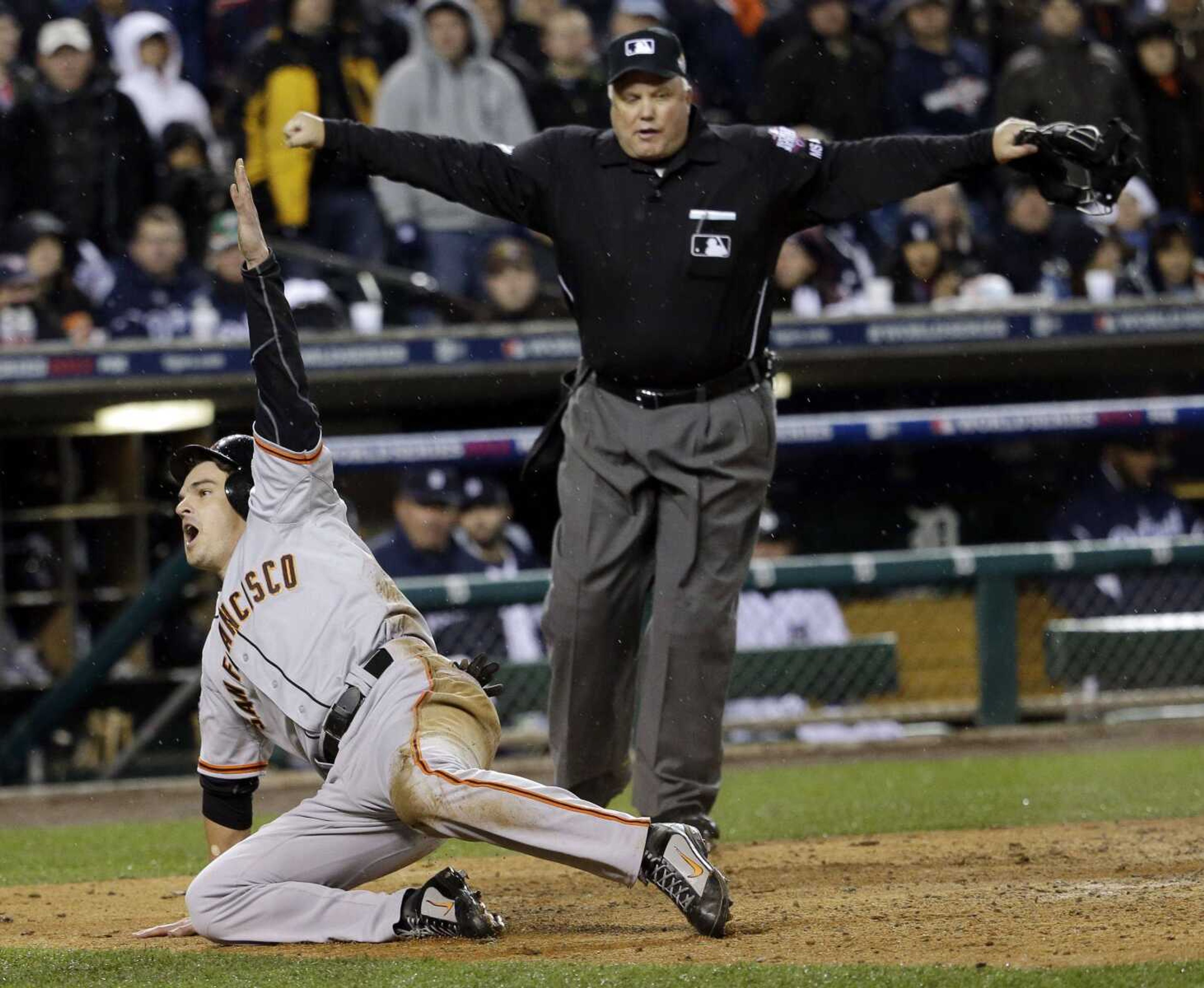 The Giants&#8217; Ryan Theriot reacts after scoring from second on a hit by Marco Scutaro during the 10th inning of Game 4 of the World Series against the Tigers on Sunday in Detroit. (David J. Phillip ~ Associated Press)