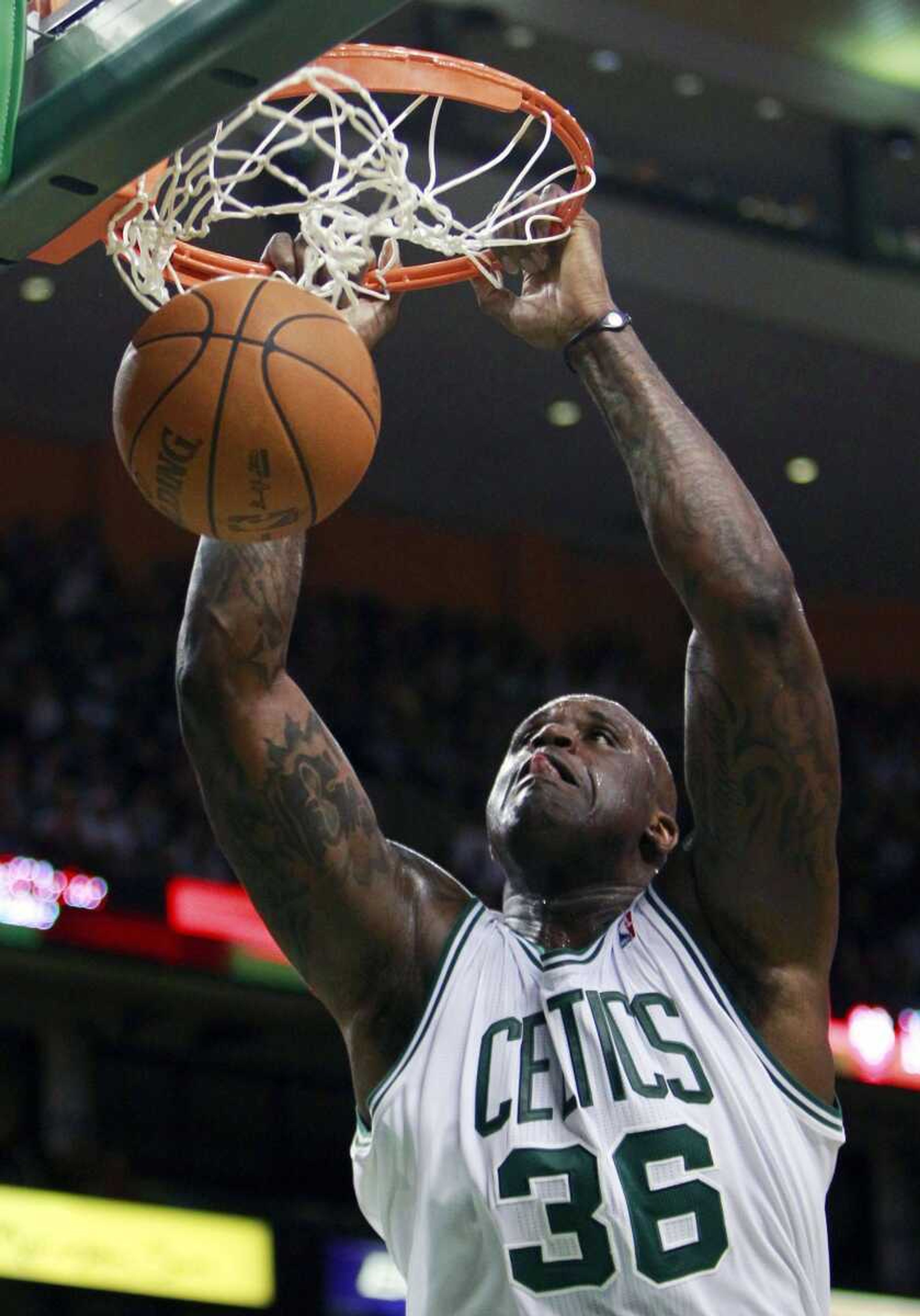 Shaquille O'Neal wears a Power Balance bracelet on his left wrist during an NBA basketball game. O'Neal credits the bracelet for helping his game, but Australian authorities last week got the California-based company to admit there is no scientific evidence supporting Power Balance's claims. (Associated Press file)