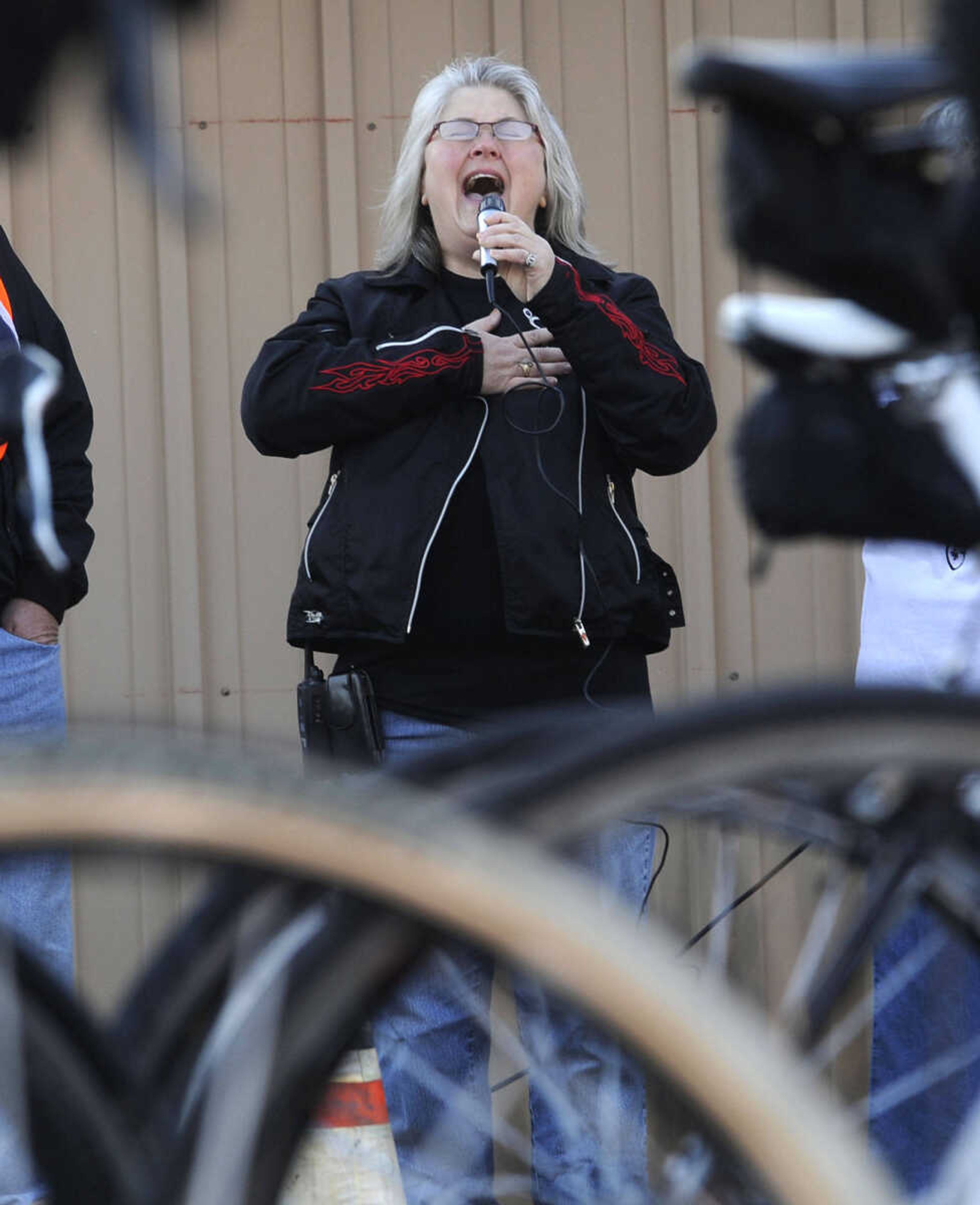 Julia Duff Thrower of Olive Branch, Ill. sings the national anthem before the start of the Tour de Shawnee.