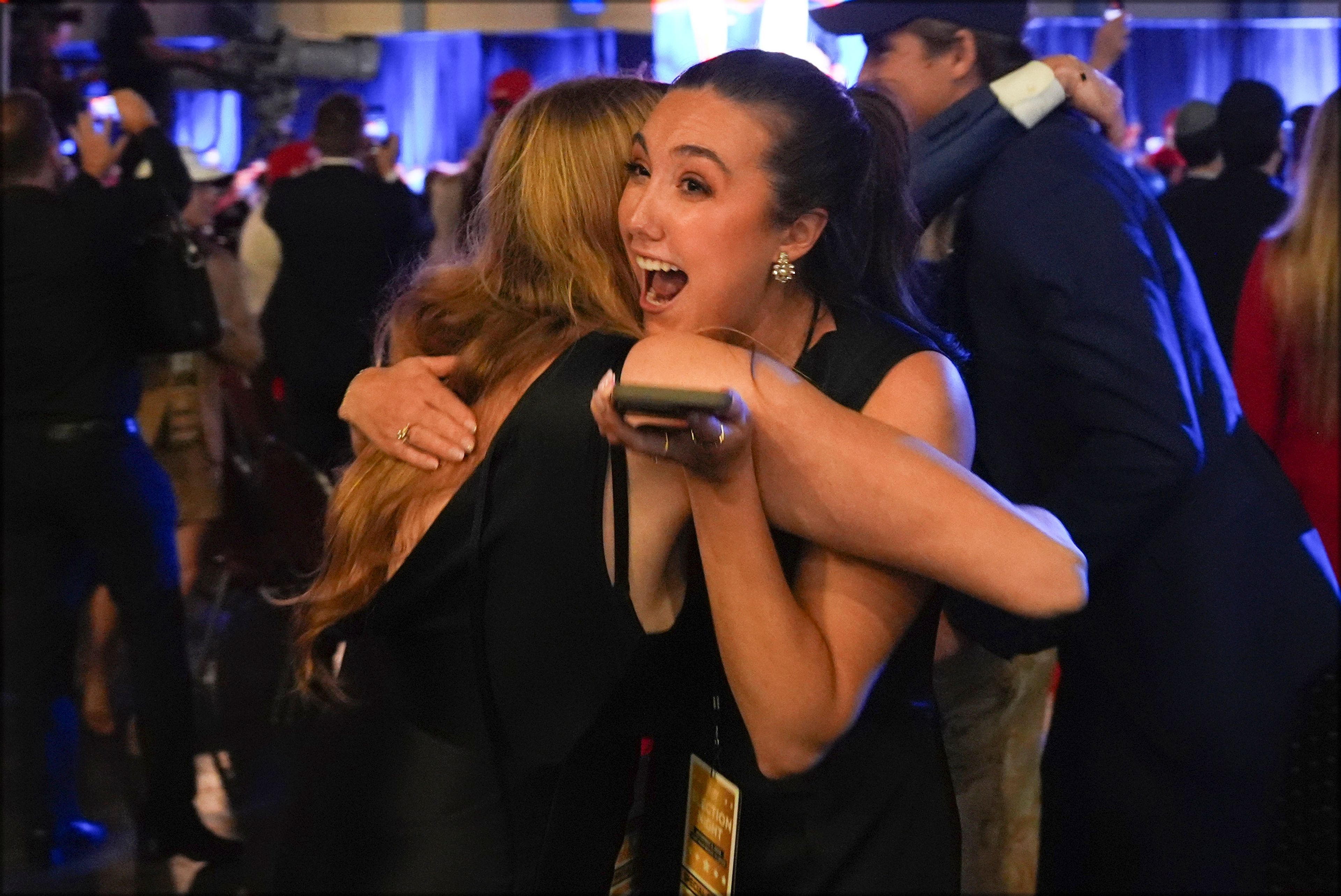 Supporters watch returns at a campaign election night watch party for Republican presidential nominee former President Donald Trump at the Palm Beach Convention Center, Wednesday, Nov. 6, 2024, in West Palm Beach, Fla. (AP Photo/Evan Vucci)