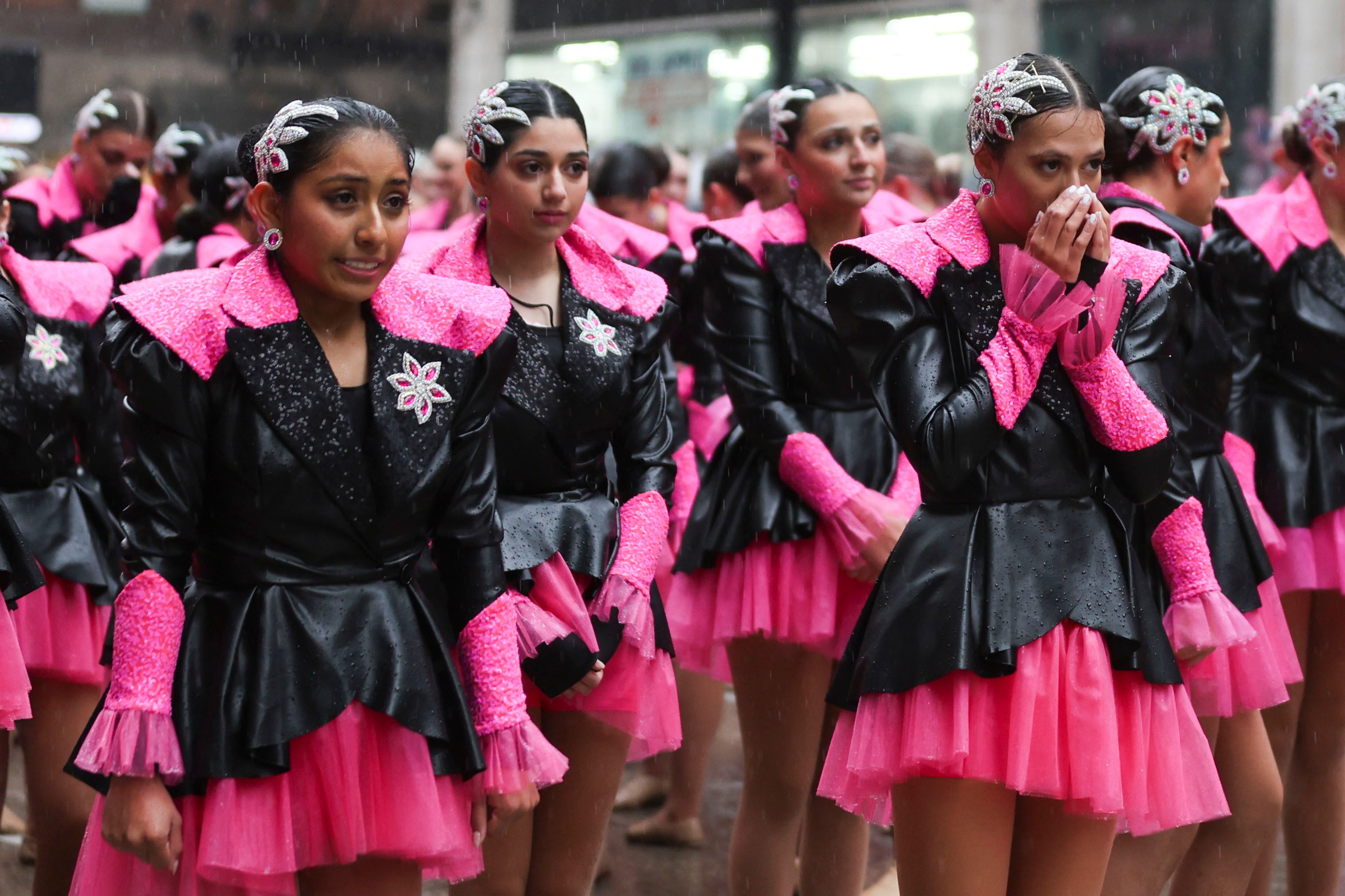 Performers attempt to stay warm as they near the end of the route during the Macy's Thanksgiving Day Parade, Thursday, Nov. 28, 2024, in New York. (AP Photo/Heather Khalifa)