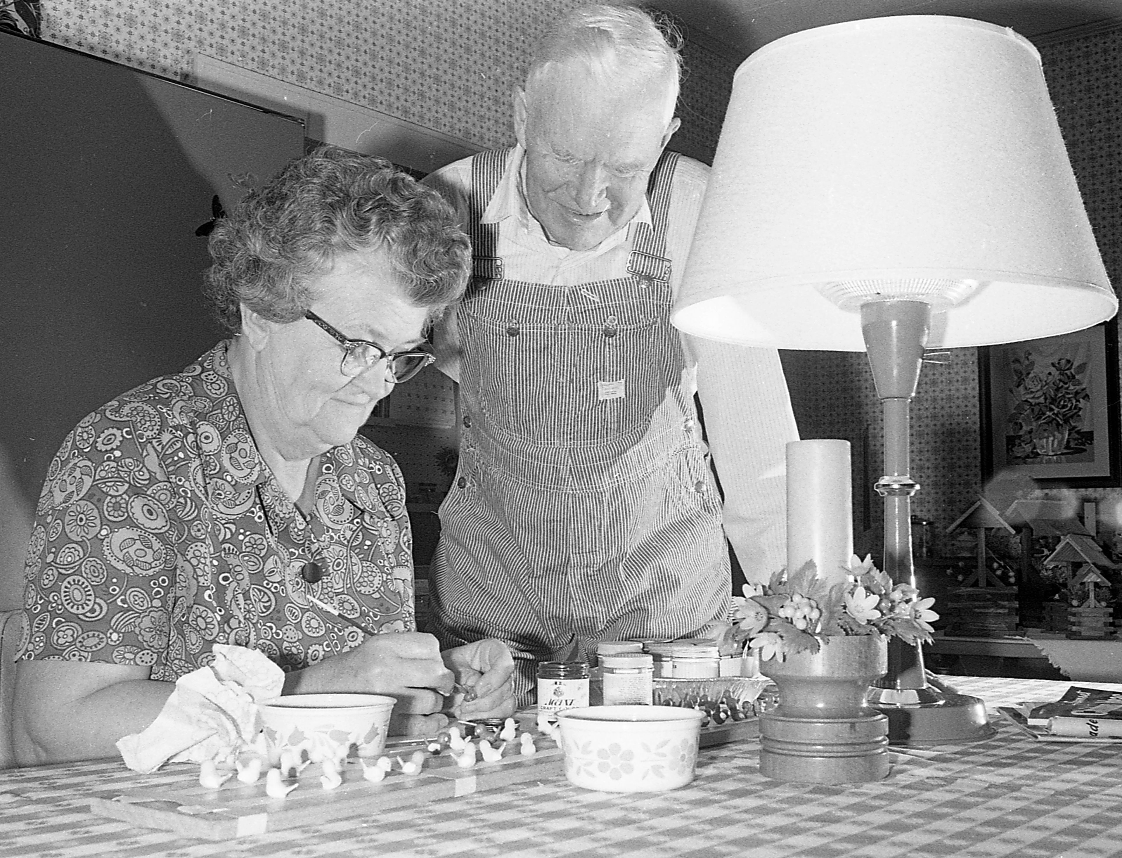 Mr. and Mrs. Ted O. Suedekum share in the joy of creating things through fine craftsmanship. Here, the couple in the kitchen of their farm home near here, which is well over 100 years old. Although Mr. Suedekum actually puts the items together, Mrs. Suedekum shares the work by staining and painting wood and adding decorative touches to his wares.