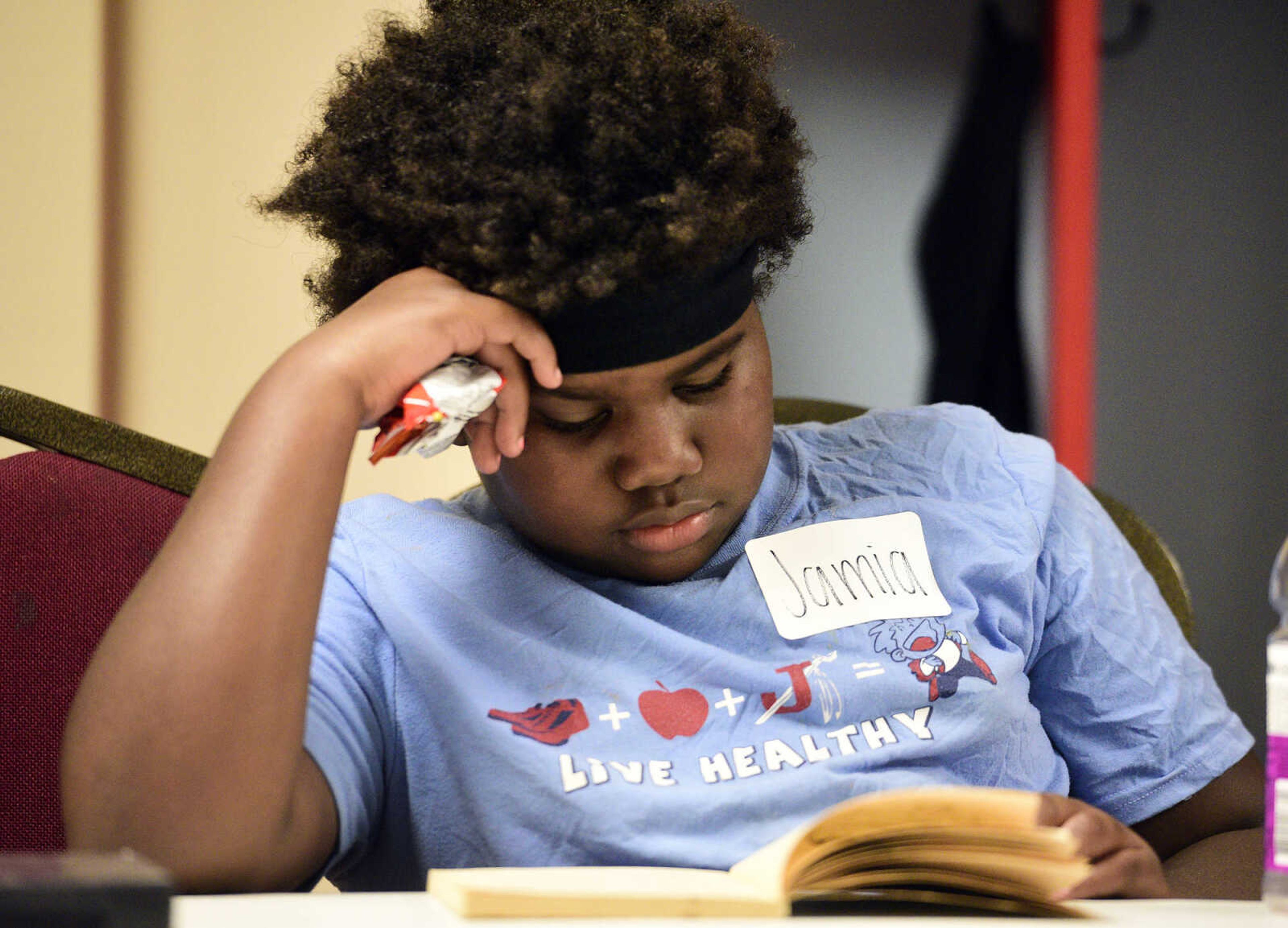 Jamia Maney reads a book on Monday, Aug. 14, 2017, during the Salvation Army's after school program at The Bridge Outreach Center in Cape Girardeau.