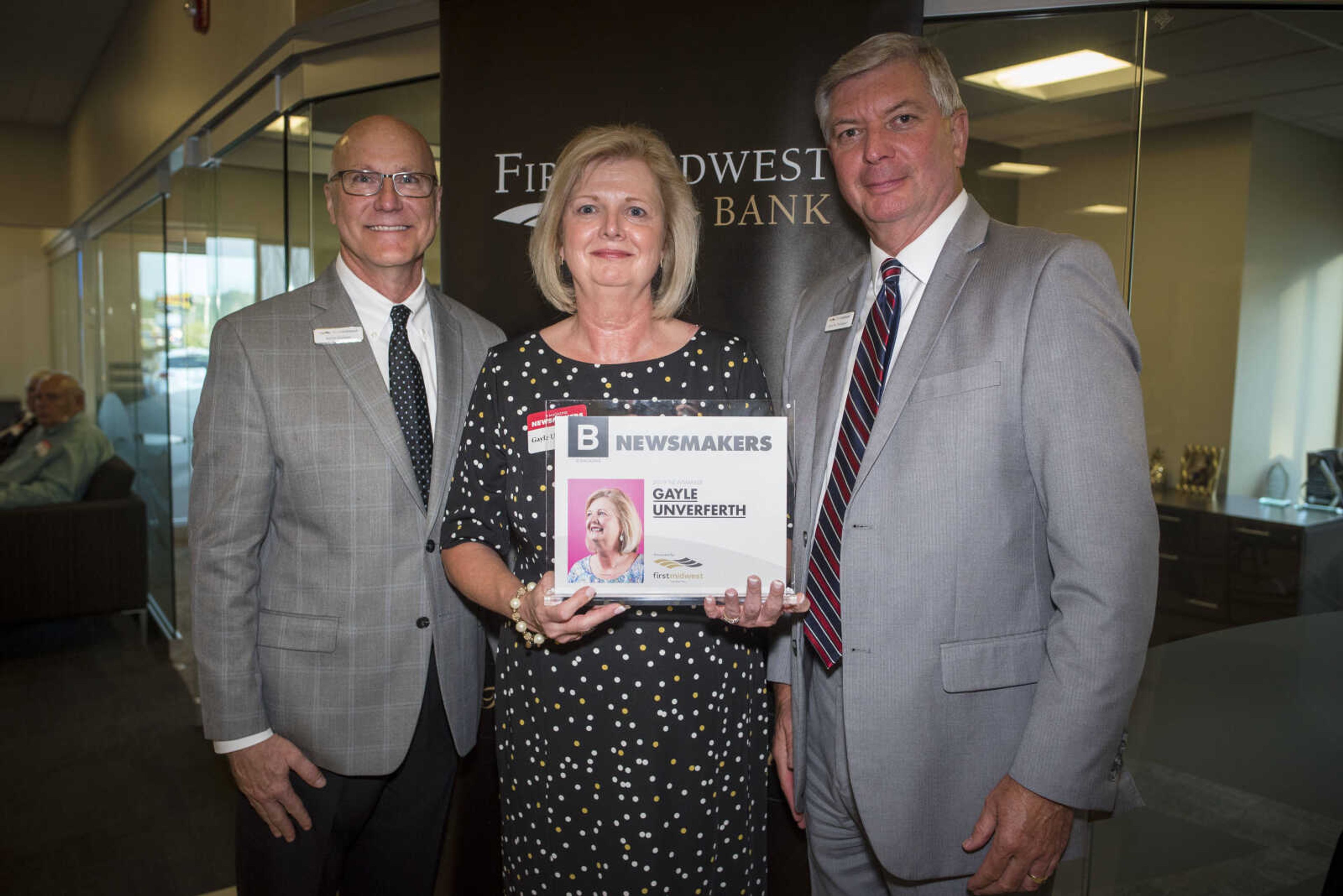 Gayle Unverferth poses for a photo with Kevin Greaser, left, community president of First Midwest Bank in Cape Girardeau, and John N. Thompson, right, community president of First Midwest Bank in Jackson, at the 2019 B Magazine Newsmakers awards reception Wednesday, Sept. 4, 2019, at First Midwest Bank in Cape Girardeau.