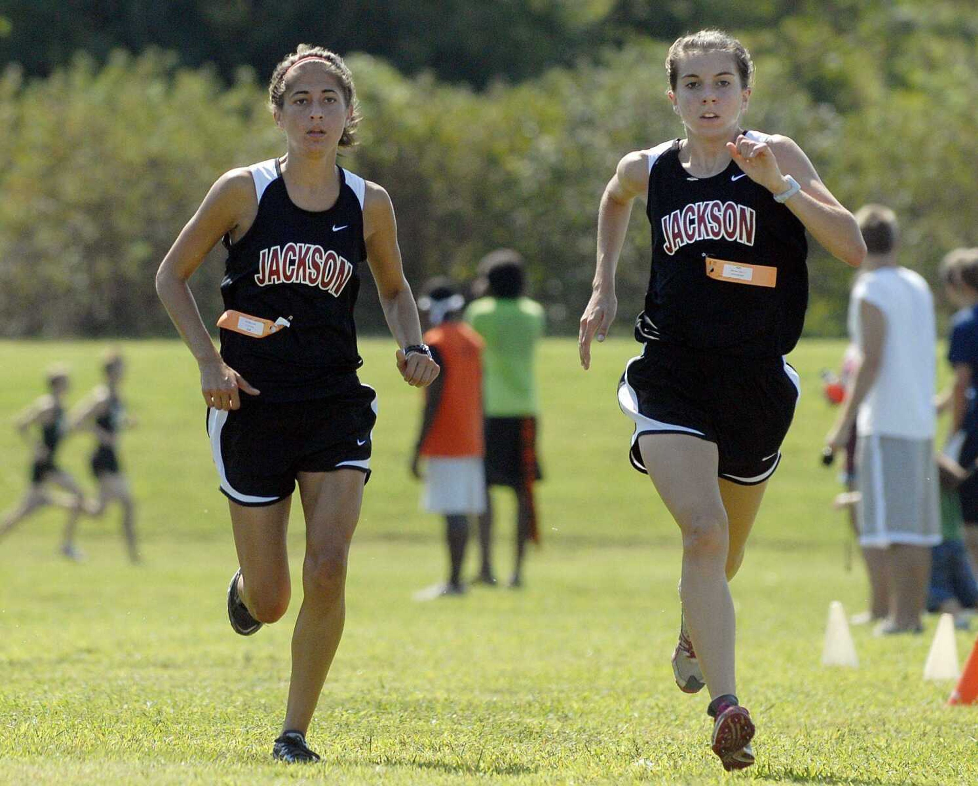 Jackson's Tori Parry, left, and Taylor Dickerson race toward the finish line Saturday at Central.