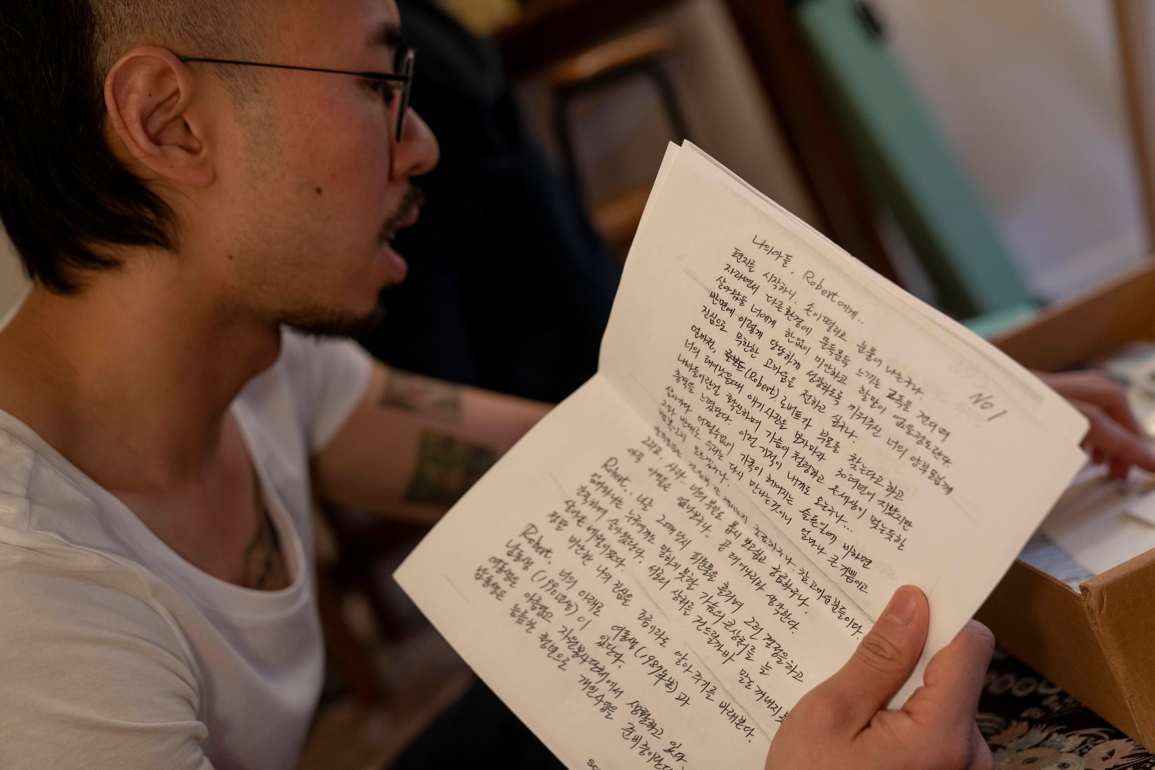 Robert Calabretta holds a letter written to him by his biological father while sifting through family mementos at his apartment, Thursday, Feb. 15, 2024, in New York. (AP Photo/David Goldman)