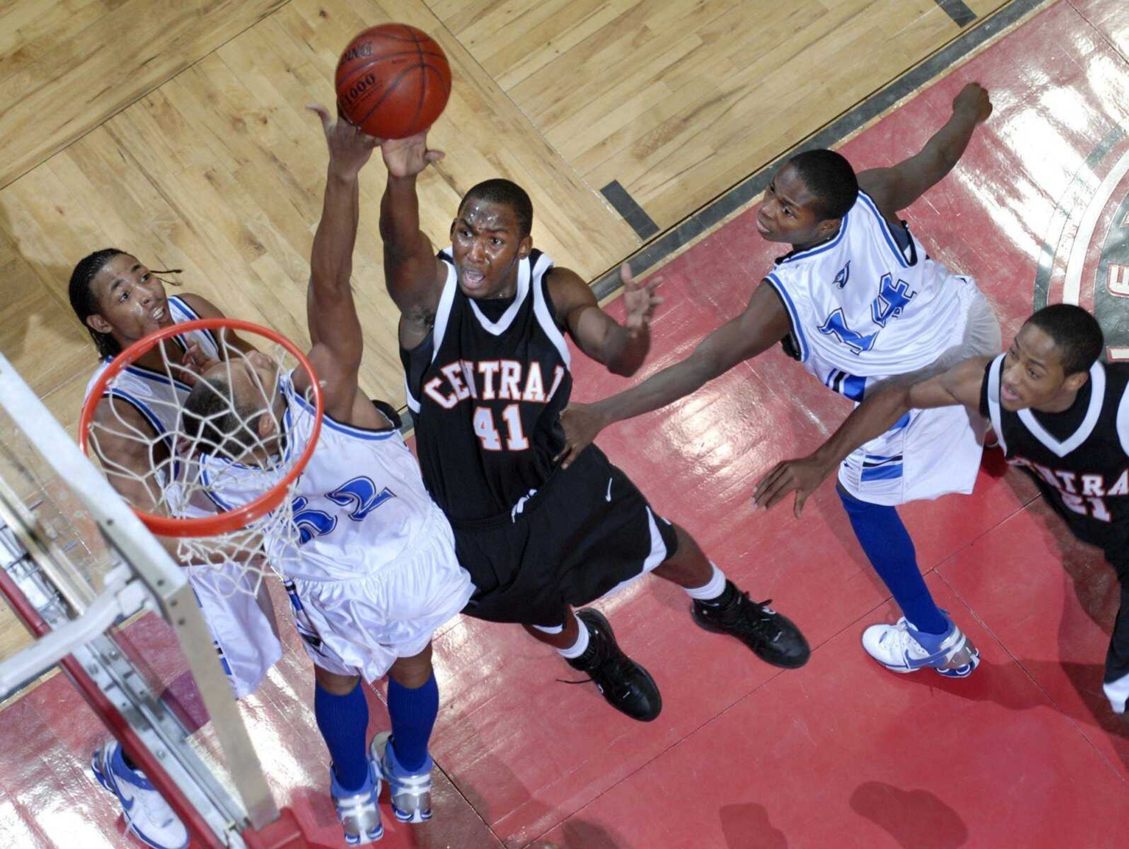 Central's Derek Walker took a shot over Charleston defenders during the third quarter of their third-place game Saturday during the Southeast Missourian Christmas Tournament at the Show Me Center. (Kit Doyle)