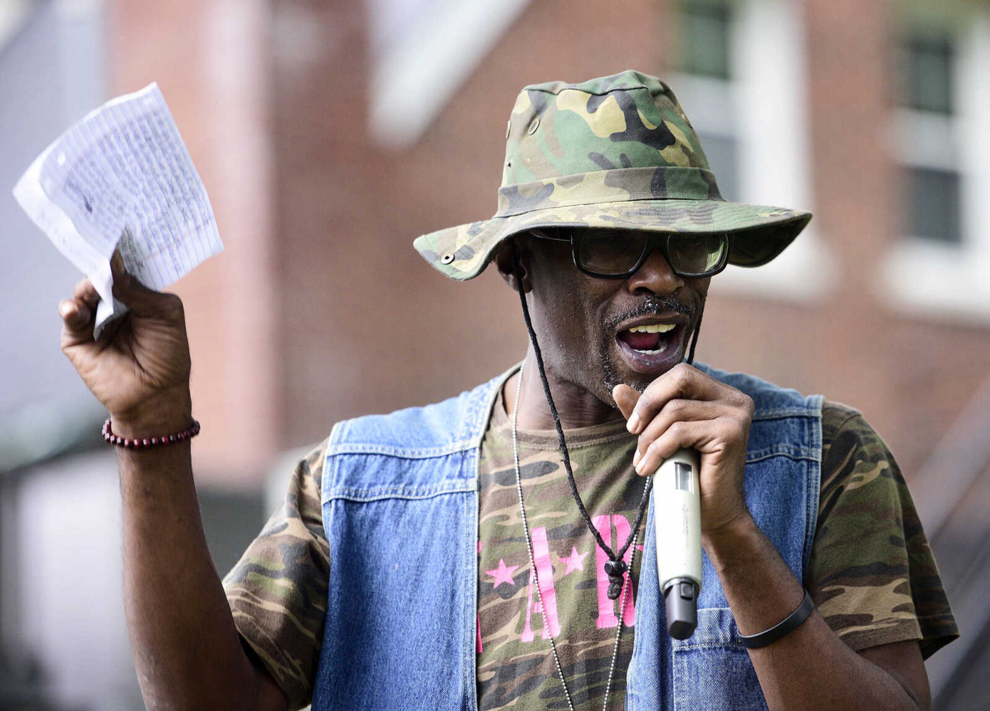 Michael "The Navigator" Council reads his poem "Executive Orders" during the Love, Not Hate rally on Sunday evening, Aug. 13, 2017, at Ivers Square in Cape Girardeau.