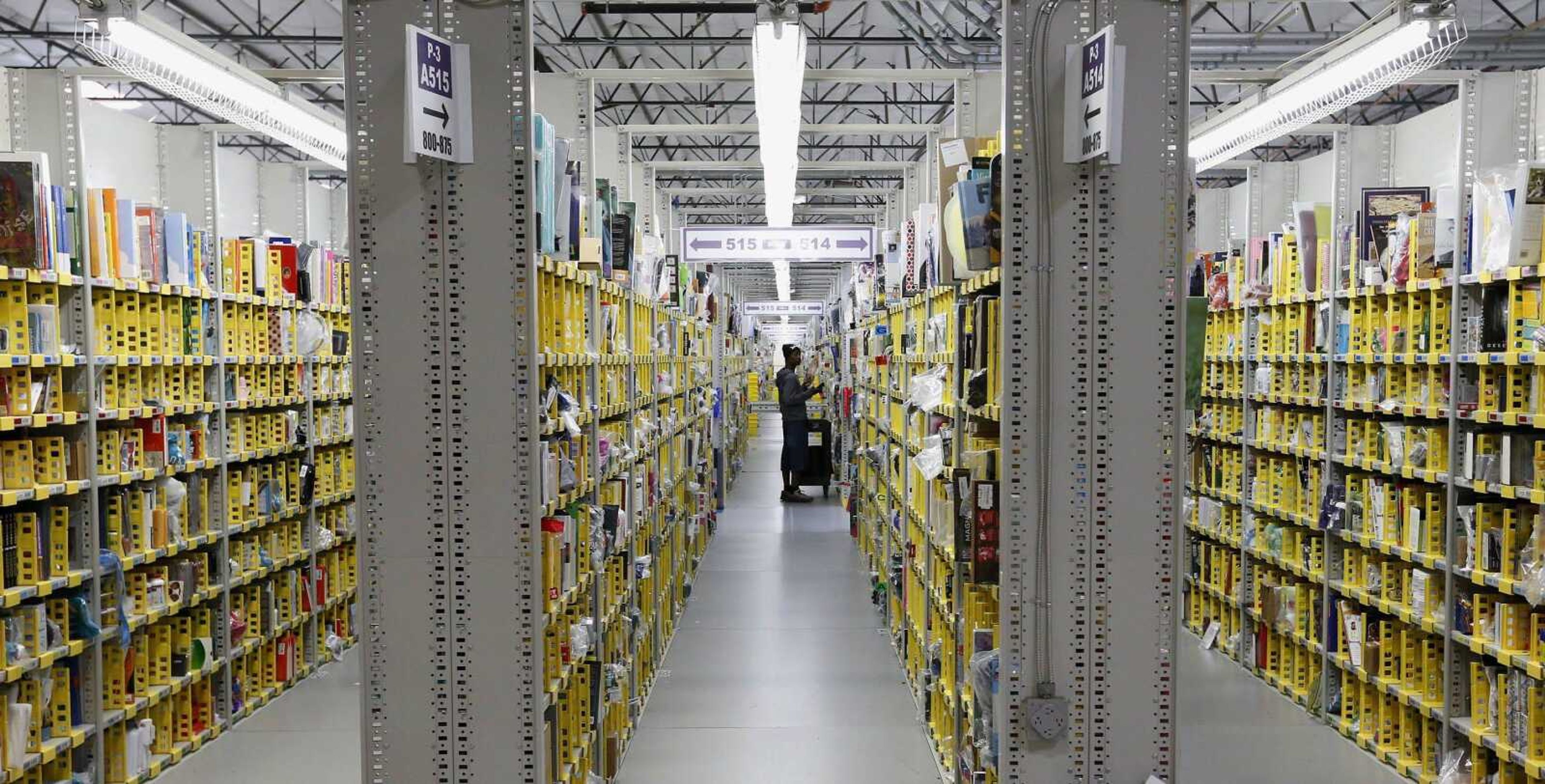 An Amazon.com employee stocks a shelf at an Amazon.com Fulfillment Center on &#8220;Cyber Monday&#8221;. (Associated Press file)