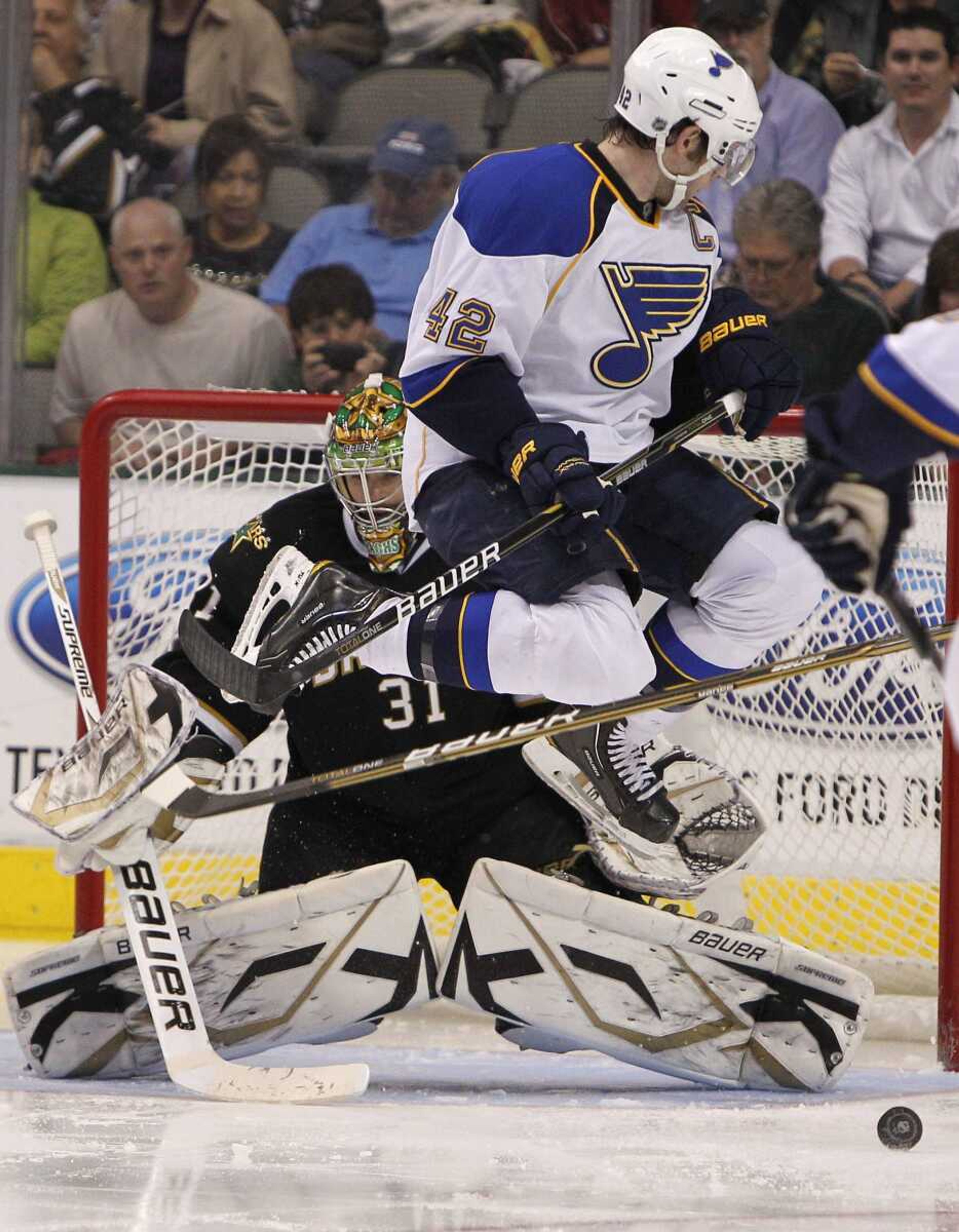 Blues center David Backes jumps out of the way of a teammate's shot as Stars goalie Richard Bachman stops the puck during the second period Saturday in Dallas. (BRANDON WADE ~ Associated Press)