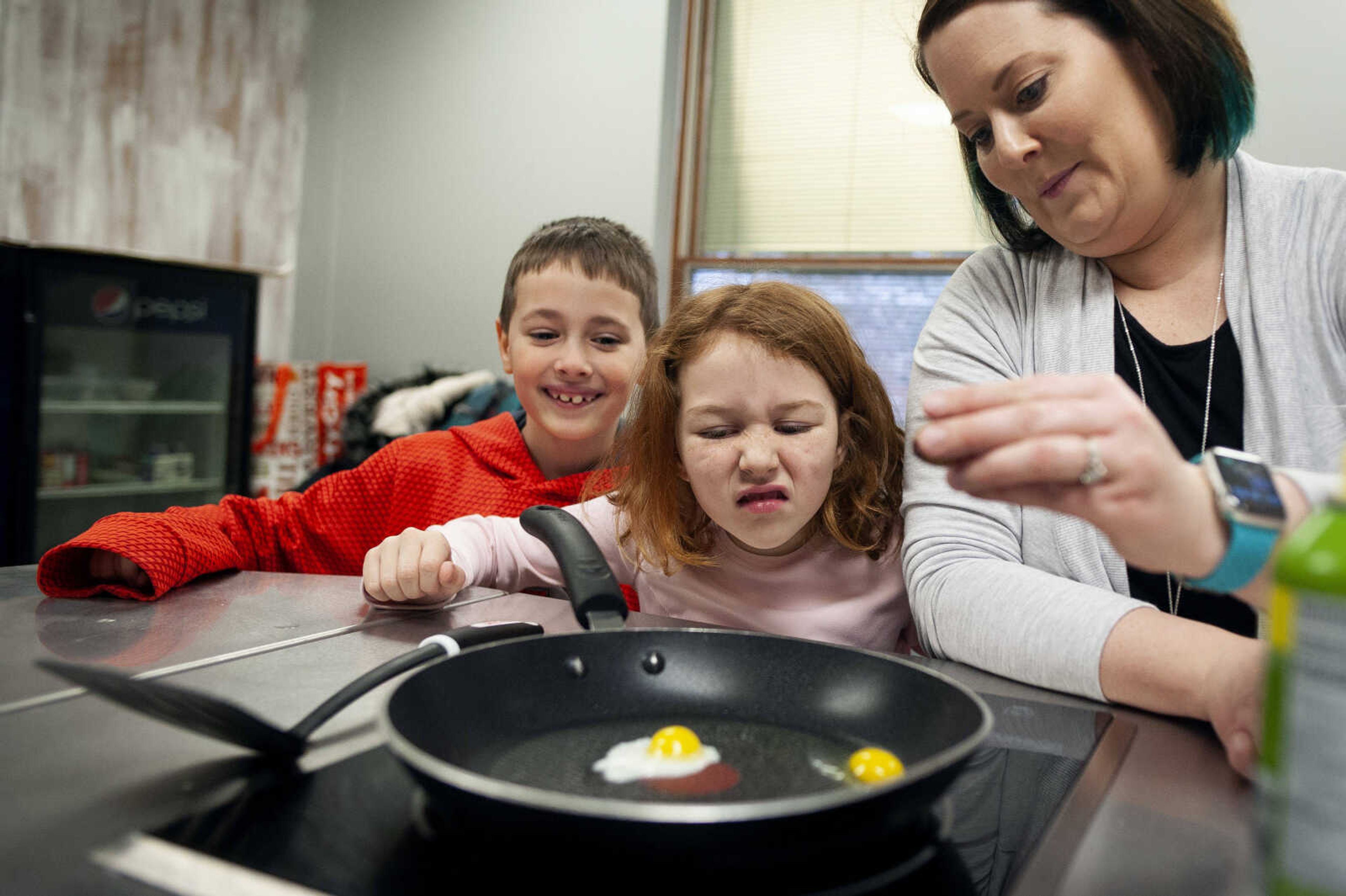 Resource reading title teacher Rachel Bentlage puts a quail egg into a pan as first-graders Gavin Ryan and Molly Mittrucker observe Thursday, Jan. 23, 2020, at Jefferson Elementary School in Cape Girardeau. 