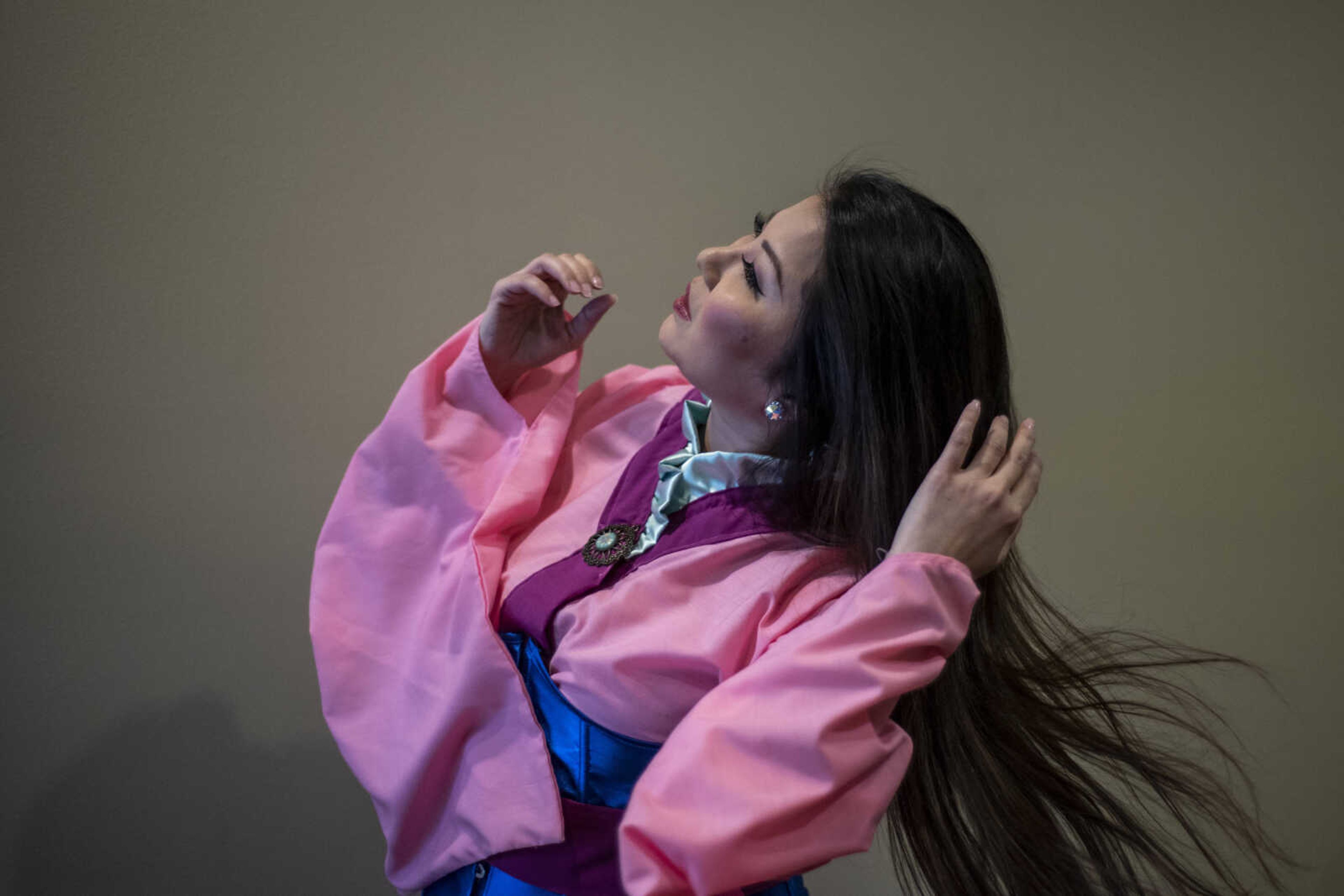 Neisha Ward portrays the role of Mulan from Disney's "Mulan" at HealthPoint Fitness Saturday, March 30, 2019, in Cape Girardeau.