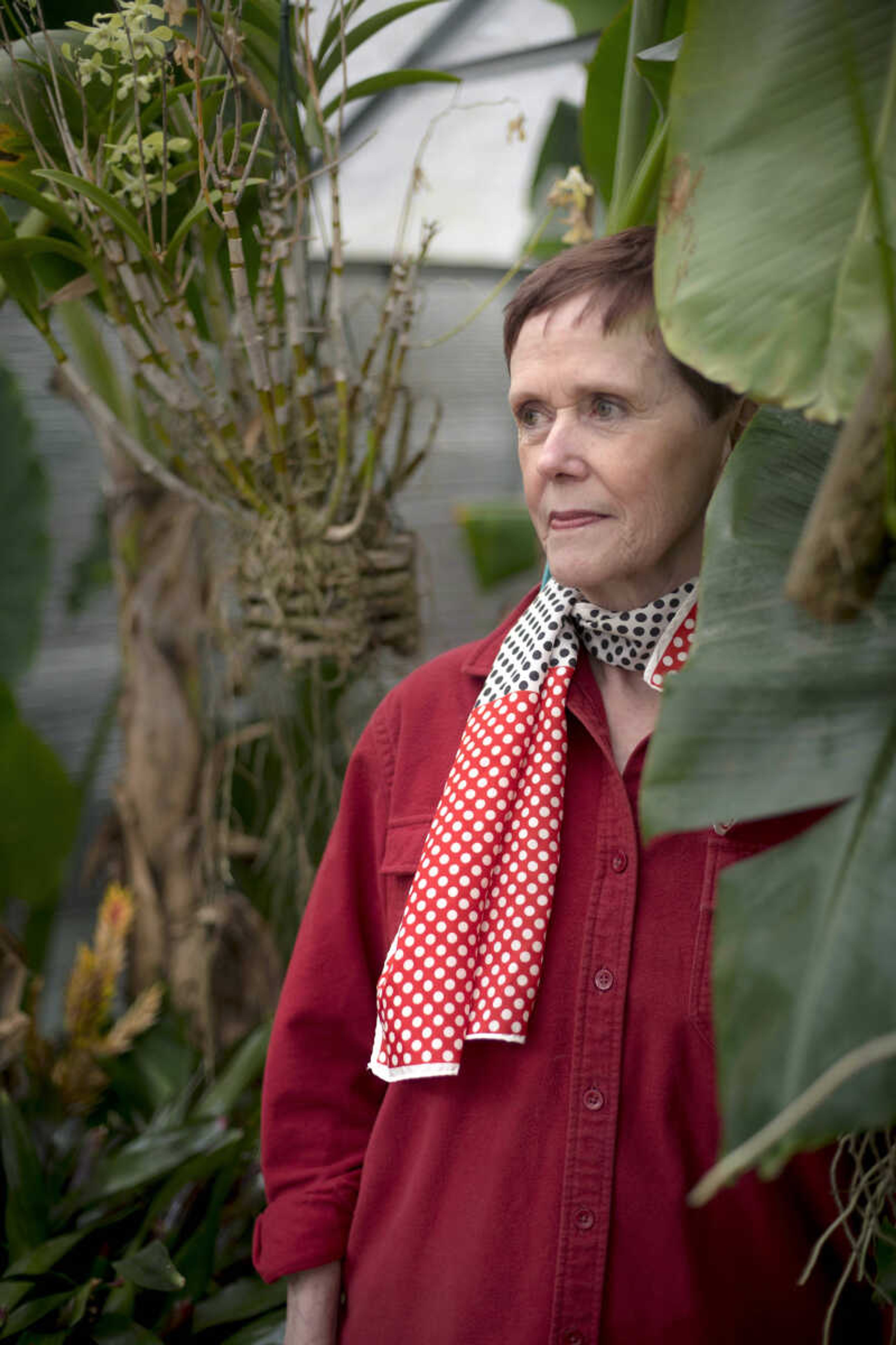 Caroline Thompson poses for a photo on Friday, Jan. 24, 2020, at Jim Hoffman's home greenhouse in Cape Girardeau.