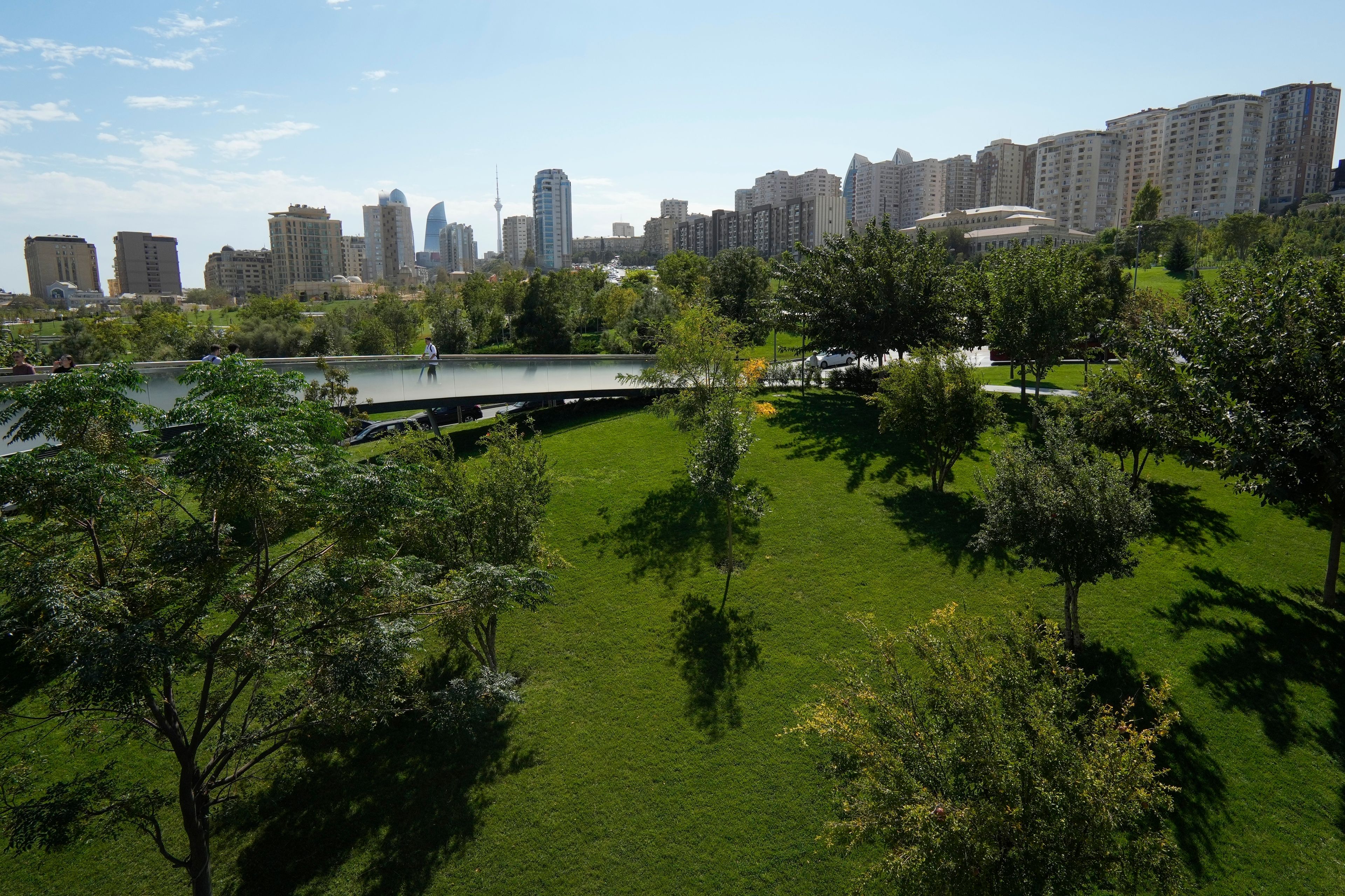 A person scooters on a walkway in Baku, Azerbaijan, Monday, Sept. 16, 2024. (AP Photo/Sergei Grits)