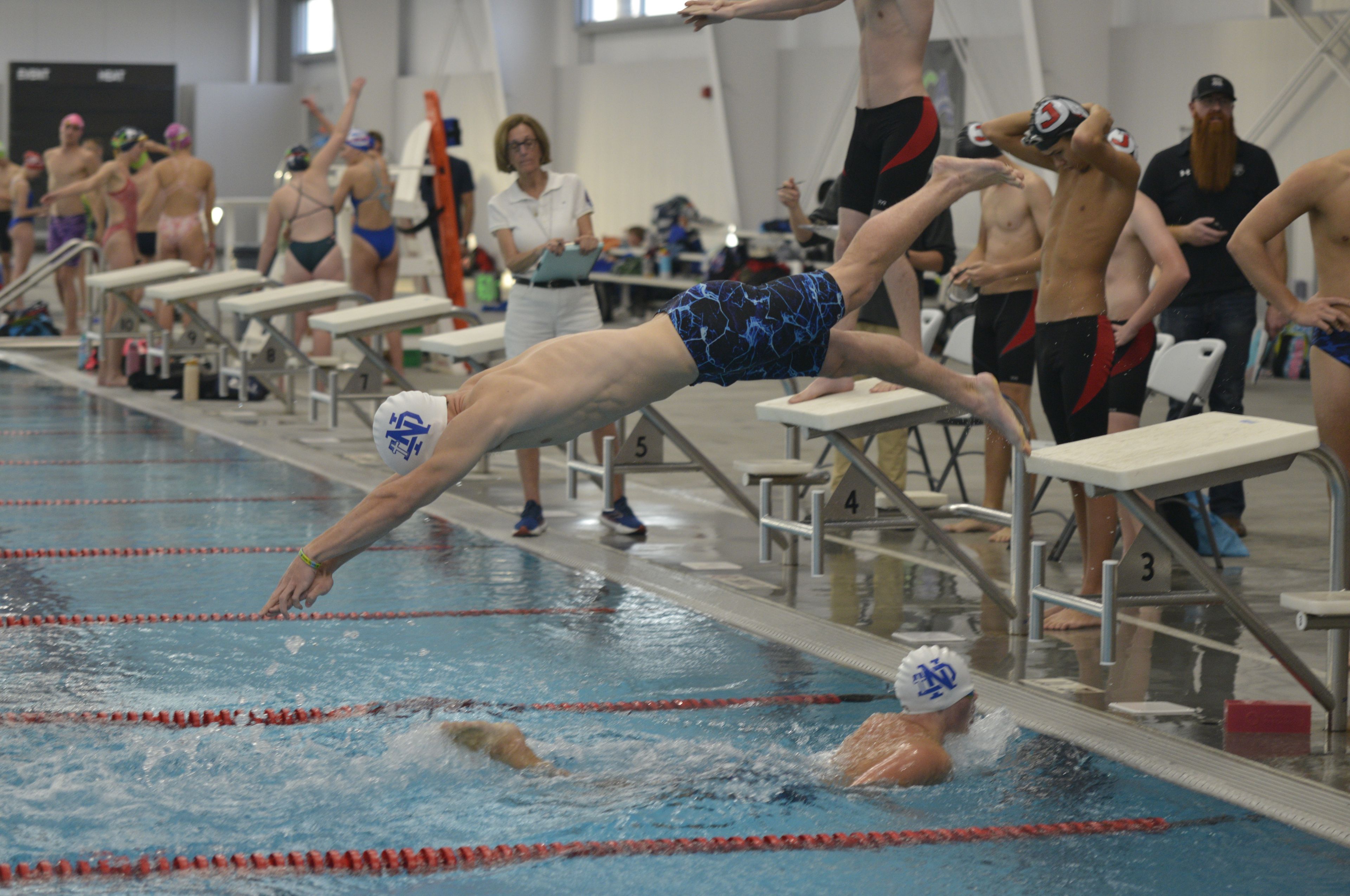 Notre Dame's Parker Hulshof dives during a relay against Jackson on Monday, Oct. 28, at the Cape Aquatic Center.