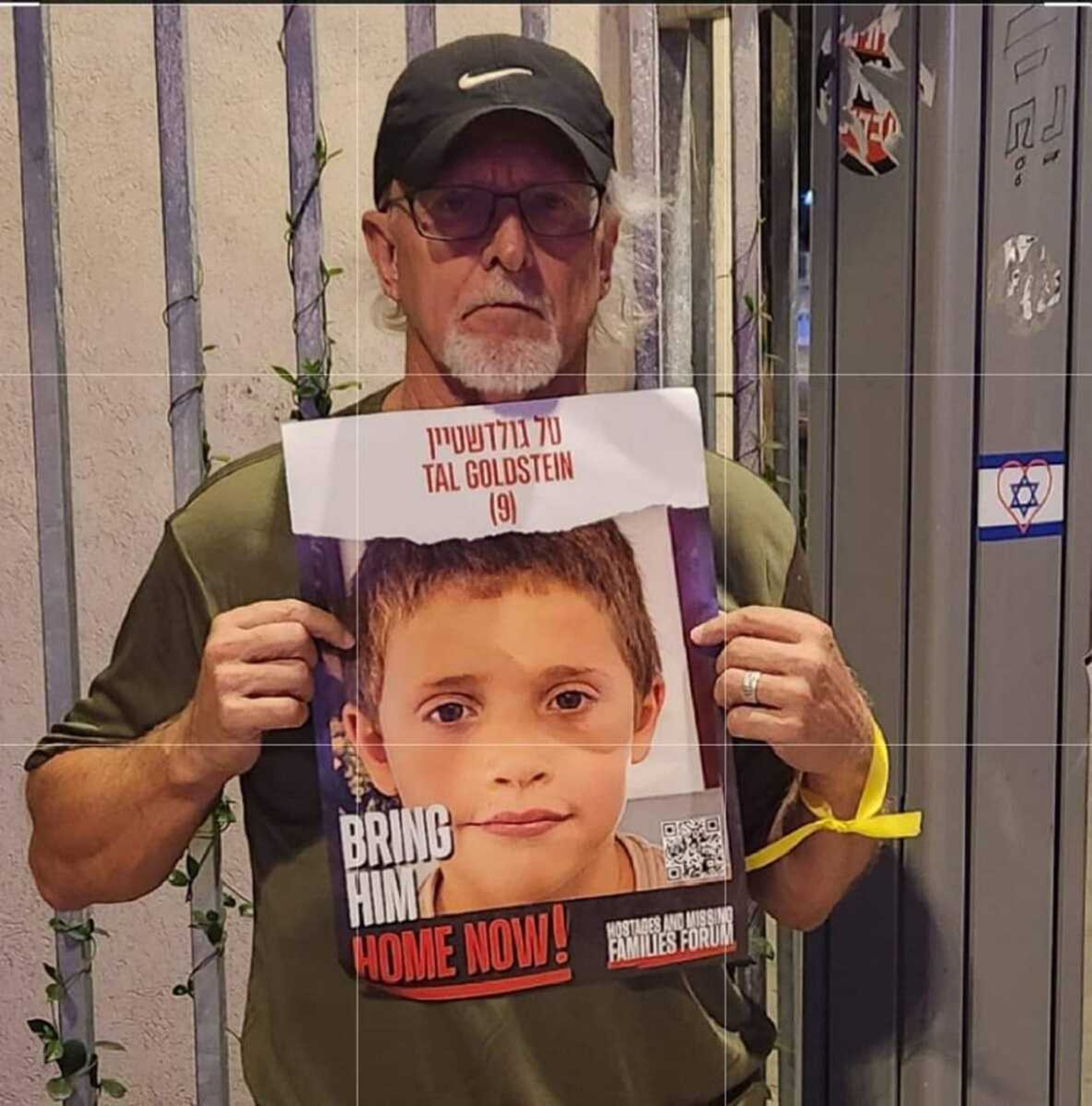 Charles Lynn, a Cape Girardeau native, stands with the poster of a child who was taken hostage from Israel in October, but has since been released by Hamas.