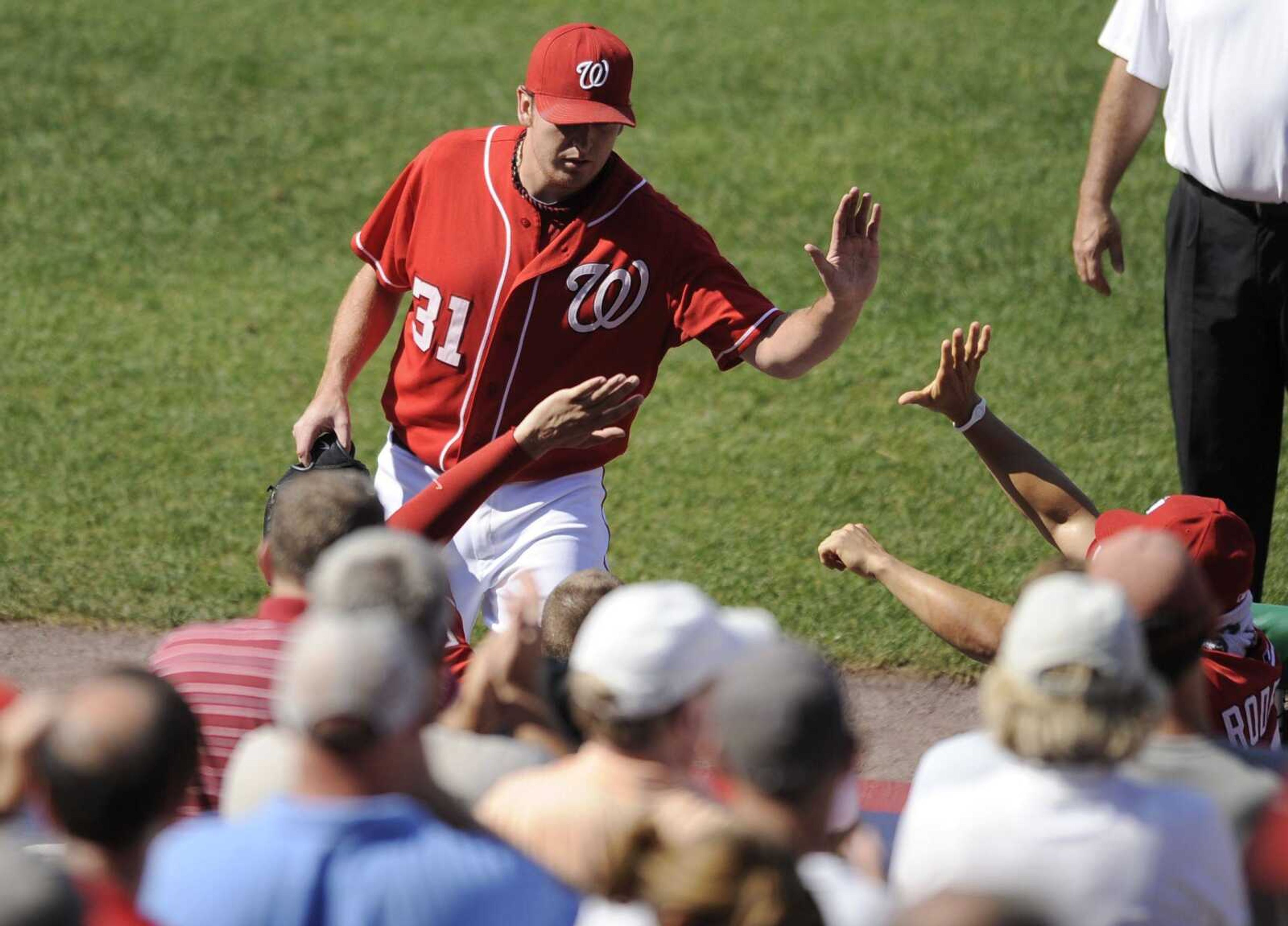 Nationals starting pitcher John Lannan is congratulated at the dugout after he left Sunday's game against the Cardinals during the eighth inning. The Nationals won 4-2. (Nick Wass ~ Associated Press)