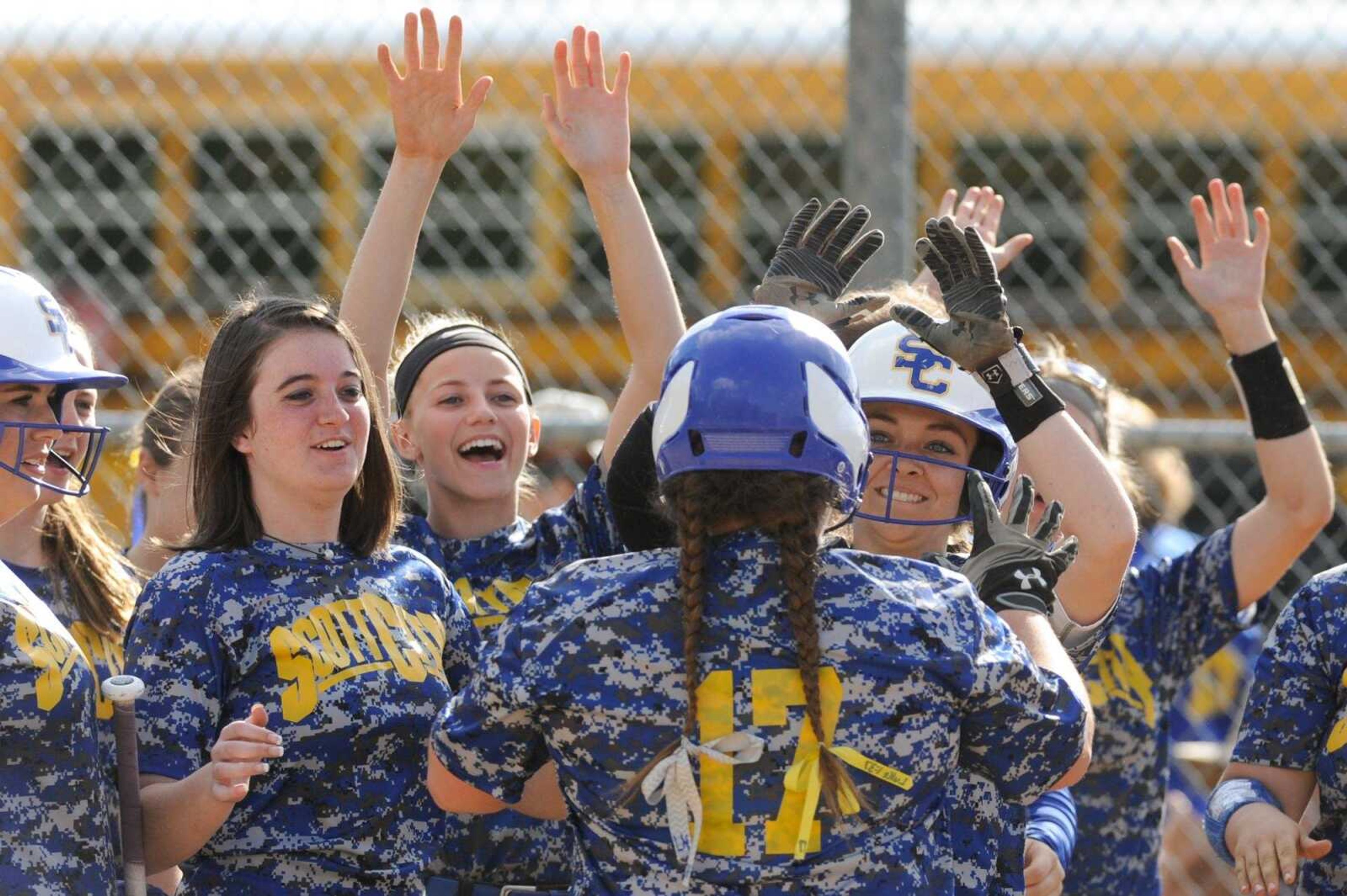 Scott City's Jamie Glastetter is met by her teammates at home plate after hitting a home run in the sixth inning against Oran during the Class 1 District 4 championship game Wednesday in Marble Hill, Missouri.