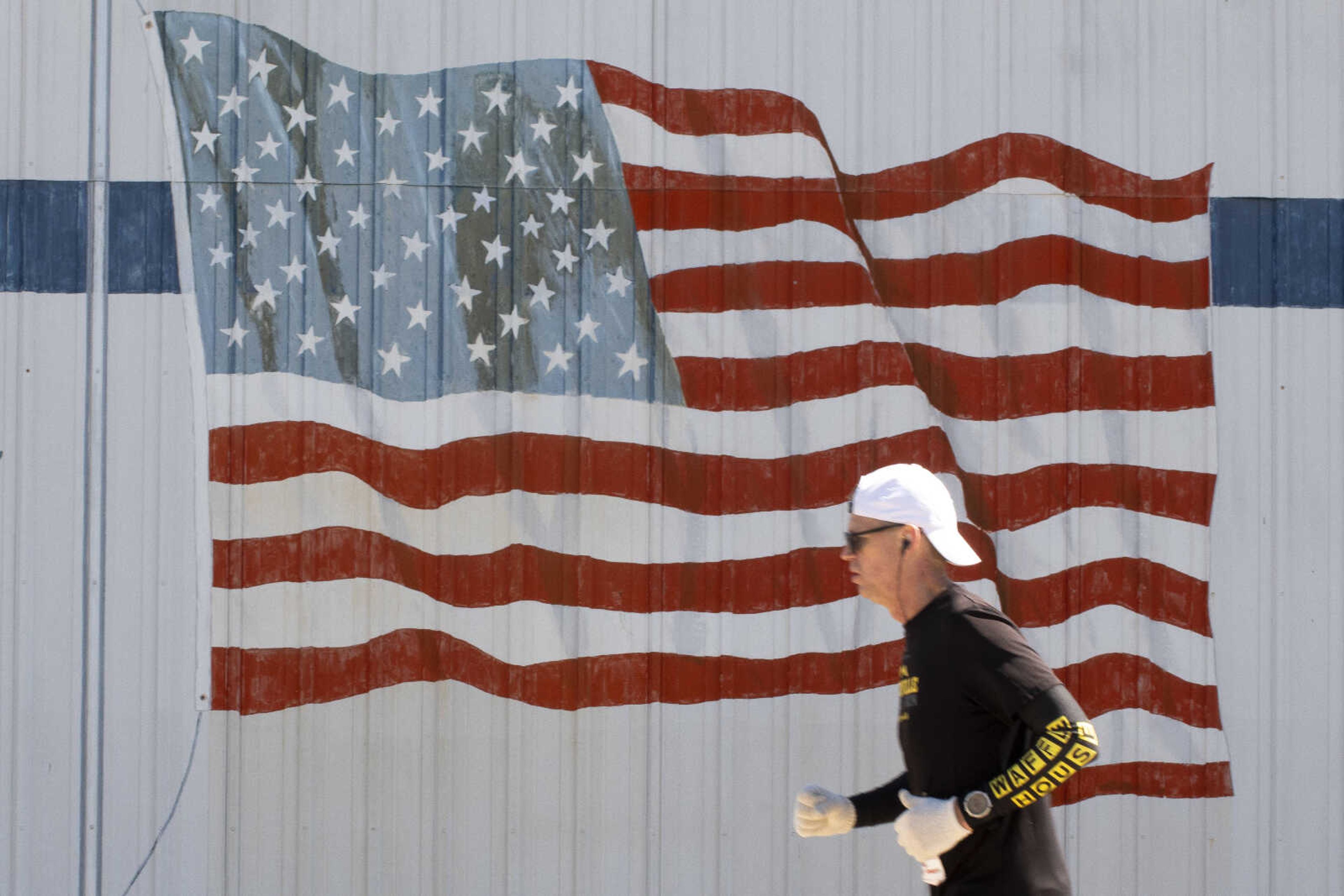 Eric Strand of Wildwood, Missouri, runs past a mural of an American flag during the 10th annual Howard Aslinger Endurance Run on Saturday, March 16, 2019, at Arena Park in Cape Girardeau.