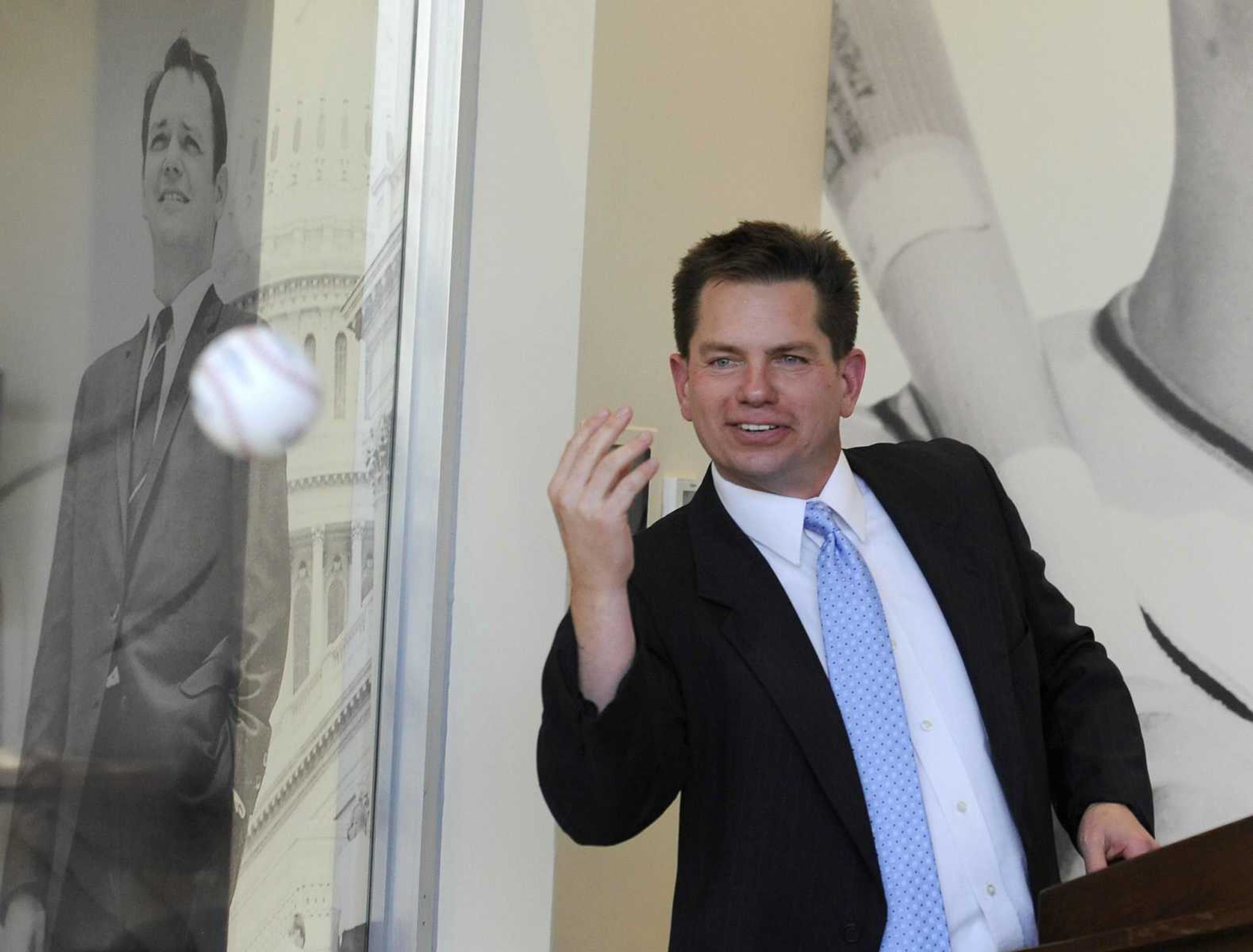 Rex Rust, co-president of Rust Communications, tosses the ball to his brother, Gary II, during the dedication and open house of Southeast Missouri State University's new Rust Center for Media on Oct. 7, 2016.