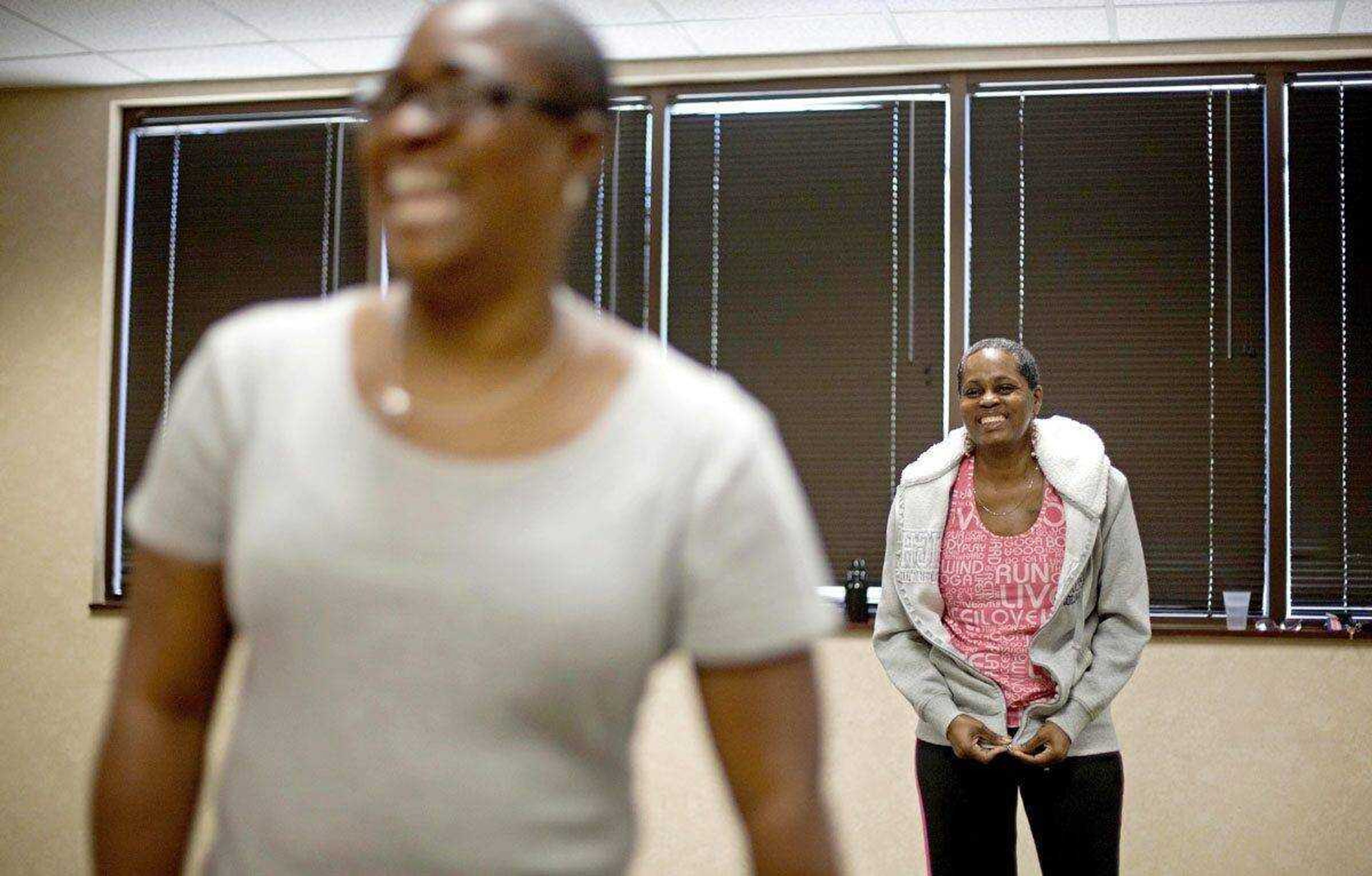 Cancer survivors Hastine Reese, 50, of Stockbridge, Ga., right, and Vivian Cox, 48, of Stone Mountain, Ga., talk Wednesday after an exercise class in Atlanta. (David Goldman ~ Associated Press)