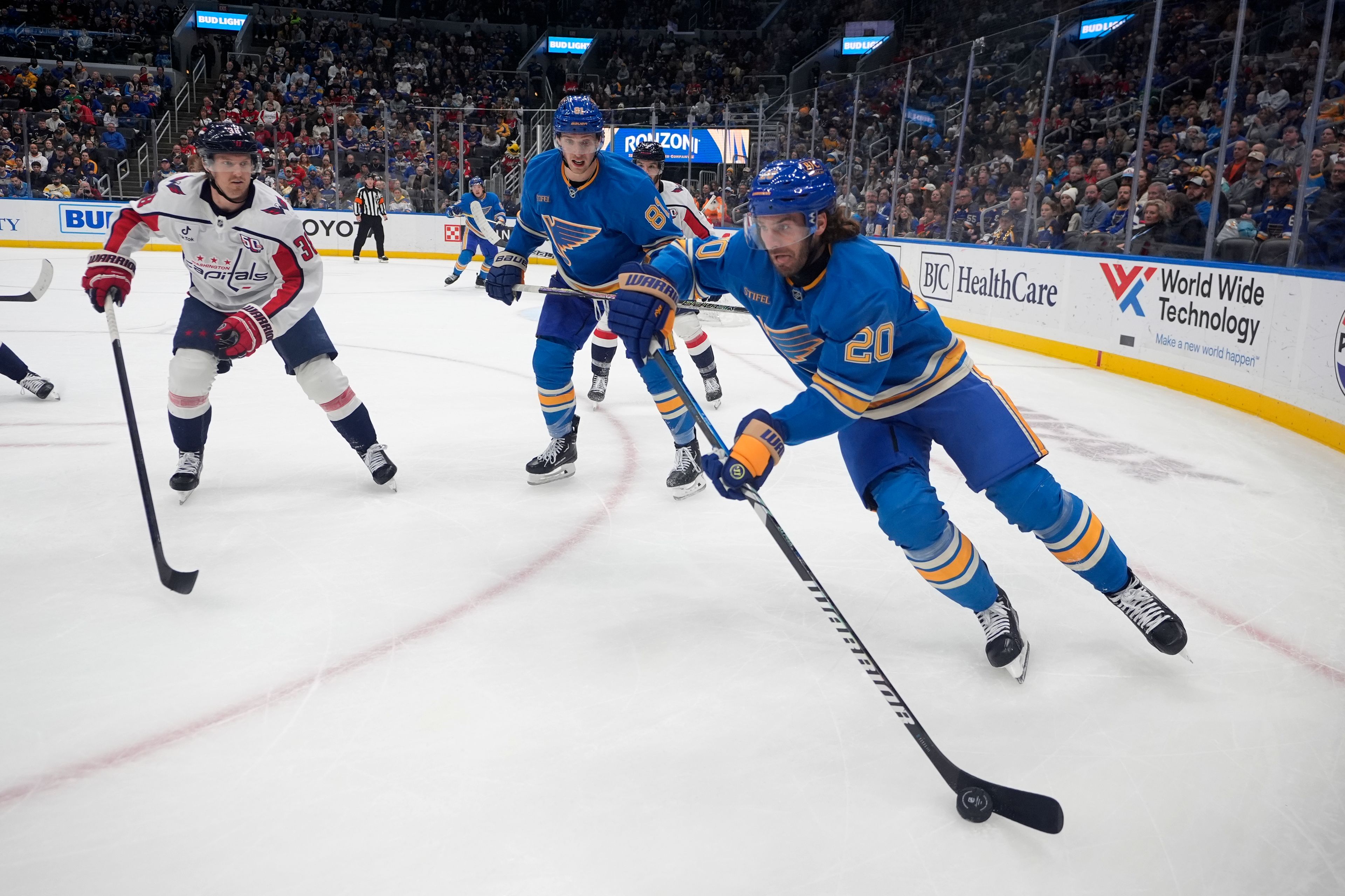 St. Louis Blues' Brandon Saad (20) controls the puck as Blues' Dylan Holloway (81) and Washington Capitals' Rasmus Sandin (38) watch during the second period of an NHL hockey game Saturday, Nov. 9, 2024, in St. Louis. (AP Photo/Jeff Roberson)