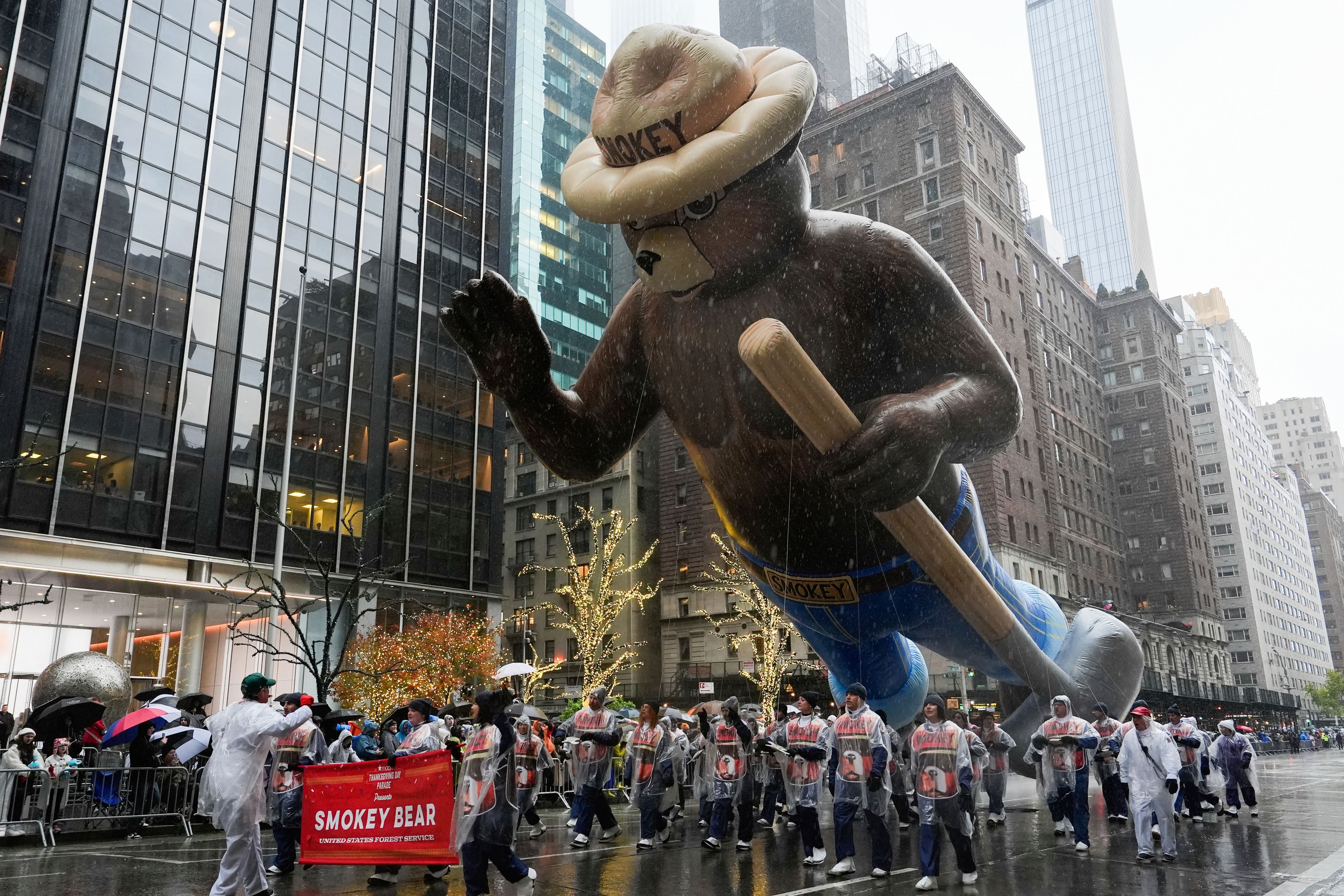 Handlers guide the Smokey Bear balloon down Sixth Avenue during the Macy's Thanksgiving Day Parade, Thursday, Nov. 28, 2024, in New York. (AP Photo/Julia Demaree Nikhinson)