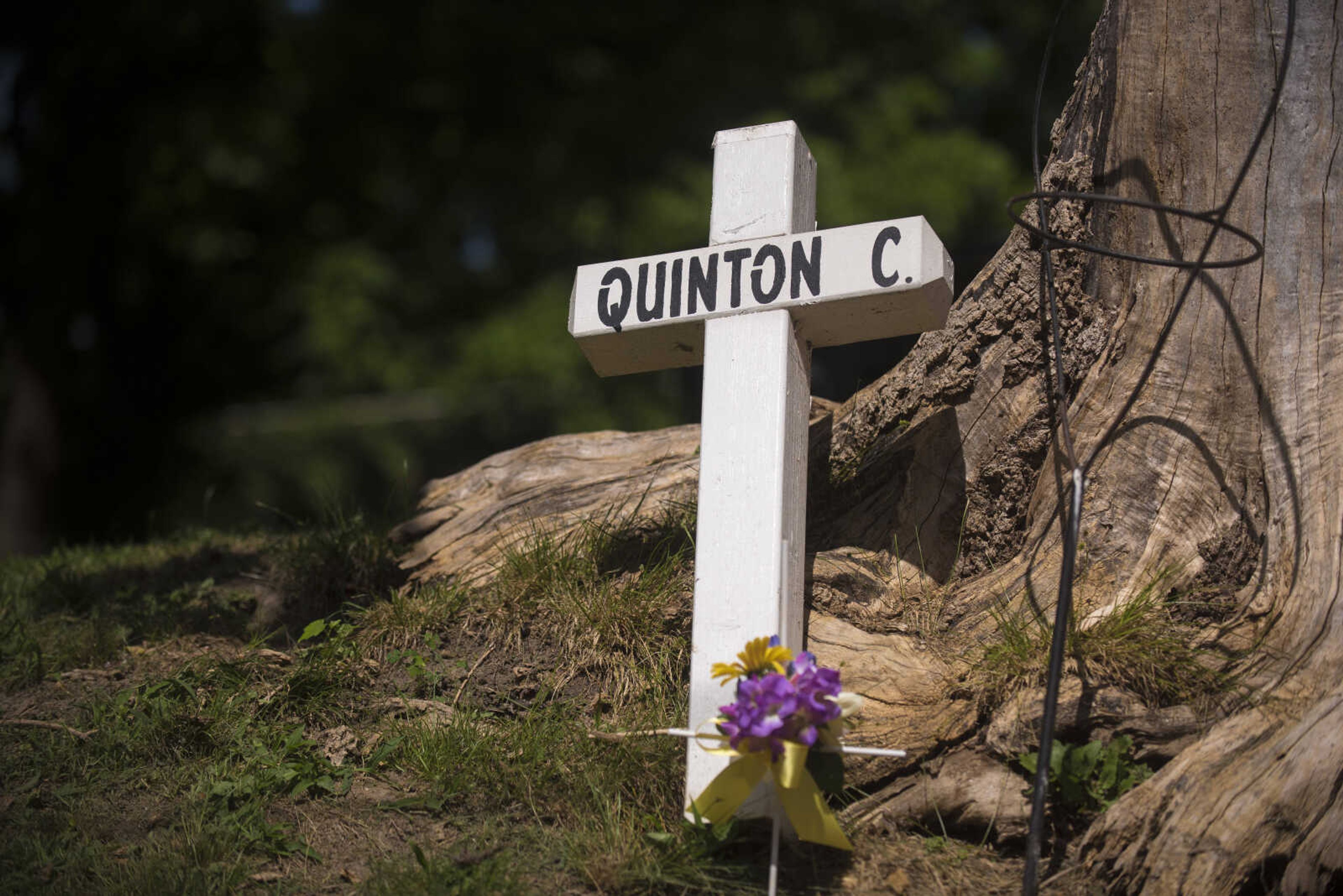 A cross is placed as a memorial for Quinton Combs who was shot and killed in 2015 during a Stop Needless Acts of Violence Please (SNAP) prayer march Saturday, June 10, 2017 in Cape Girardeau.