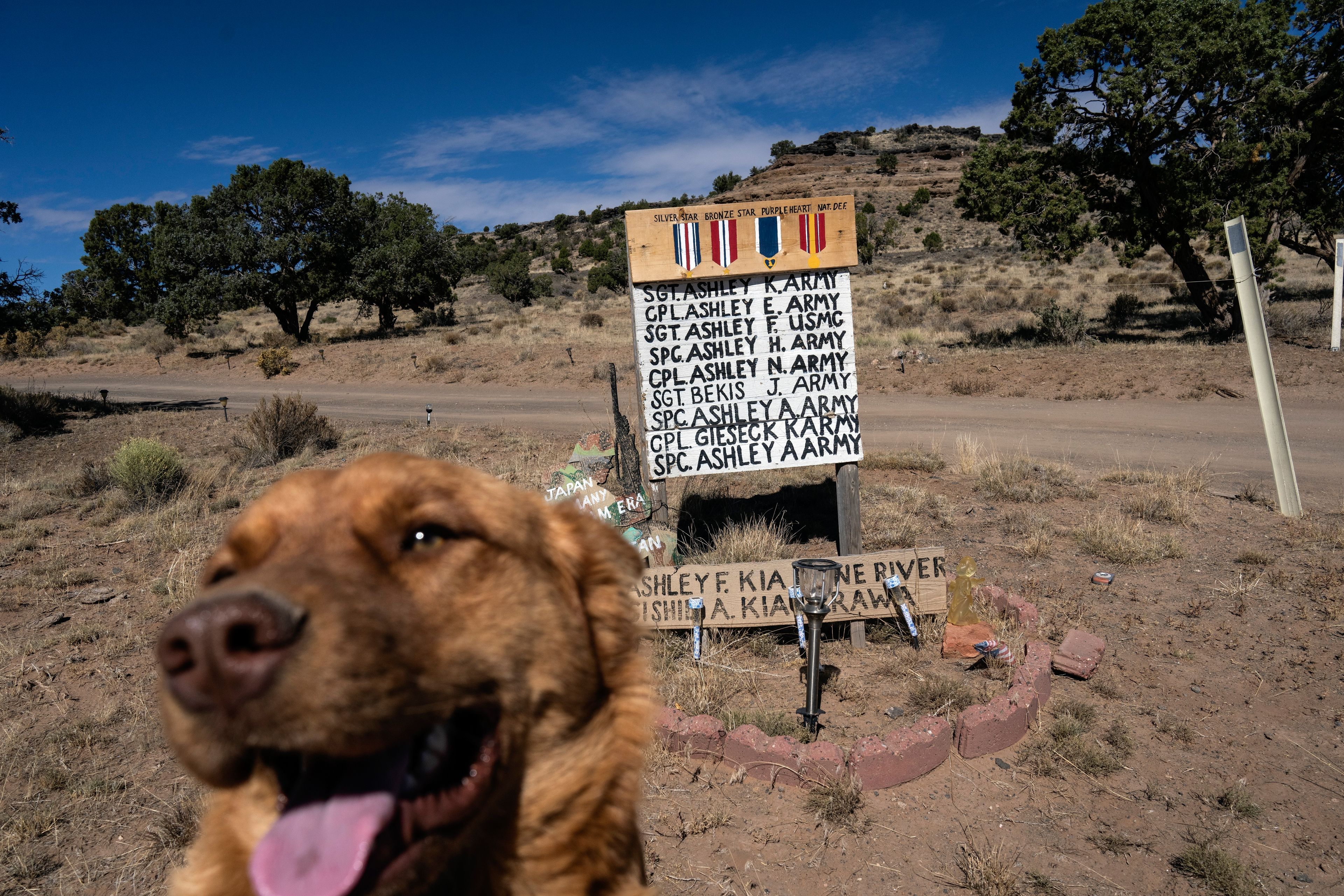 The names of Ashley family members who served in the U.S. military, are written on a sign, displayed outside the family home, on the Navajo Nation in Dilkon, Ariz, Wednesday, Oct. 16, 2024. (AP Photo/Rodrigo Abd)