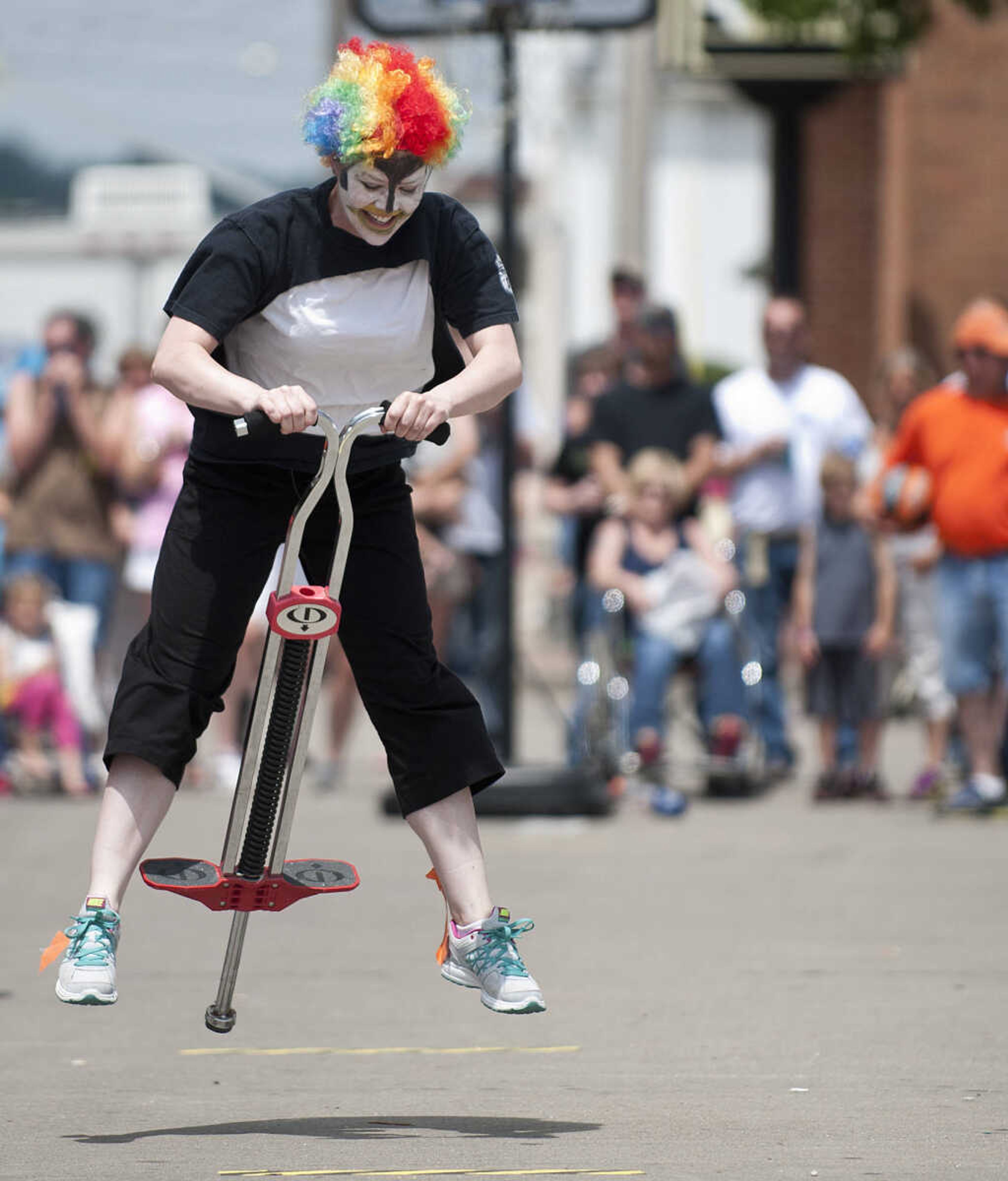 Sarah Hart rides a pogo stick while competing in the Perryville Mayfest Bed Races Saturday, May 10, in Perryville, Mo.