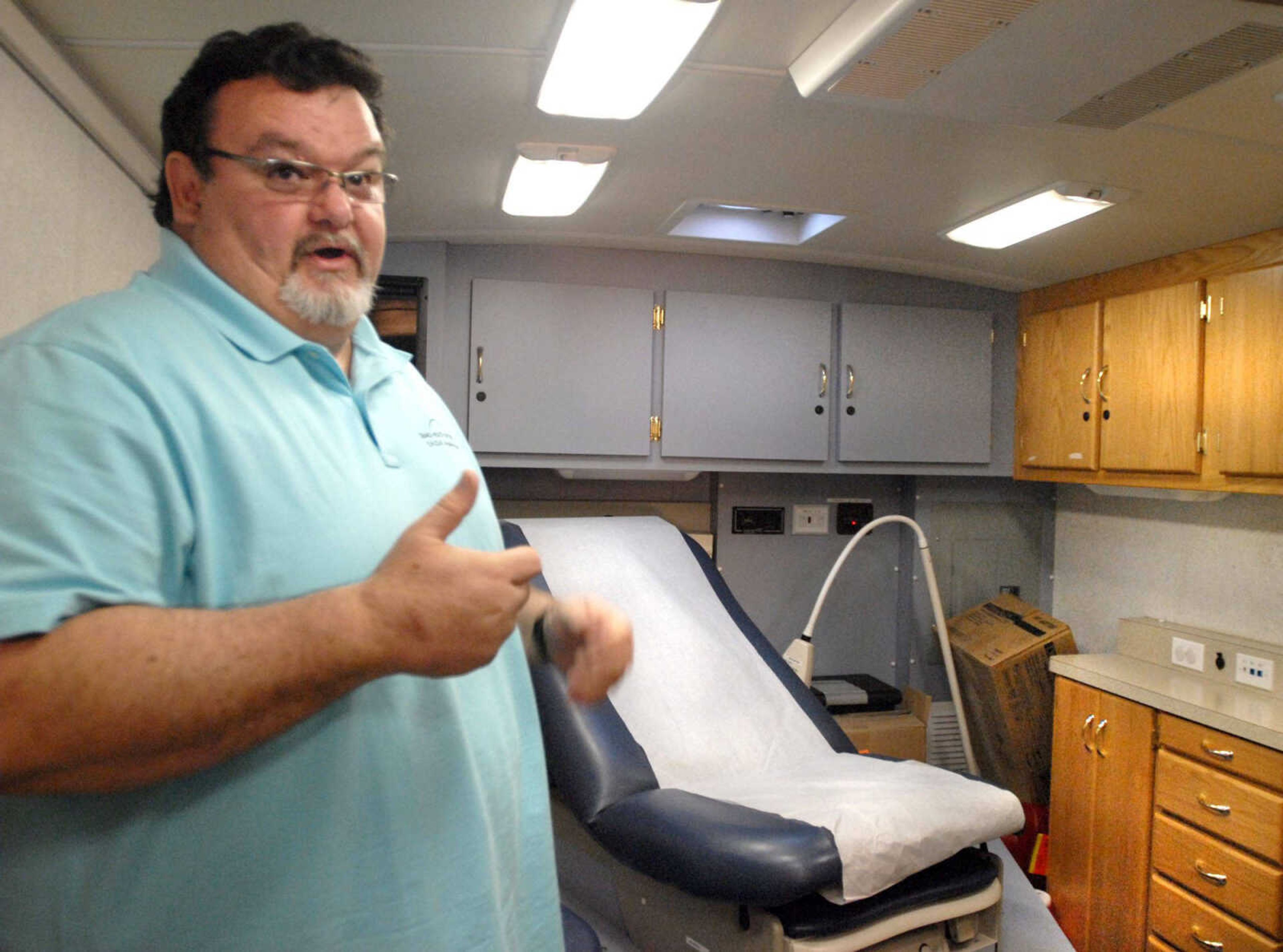 The Southeast Health on Wheels Mobile driver/clinical assistant Kevin DeArman shows a patients room inside the SHOW Mobile on Friday outside the River Campus of Southeast Missouri State University in Cape Girardeau. (Laura Simon)