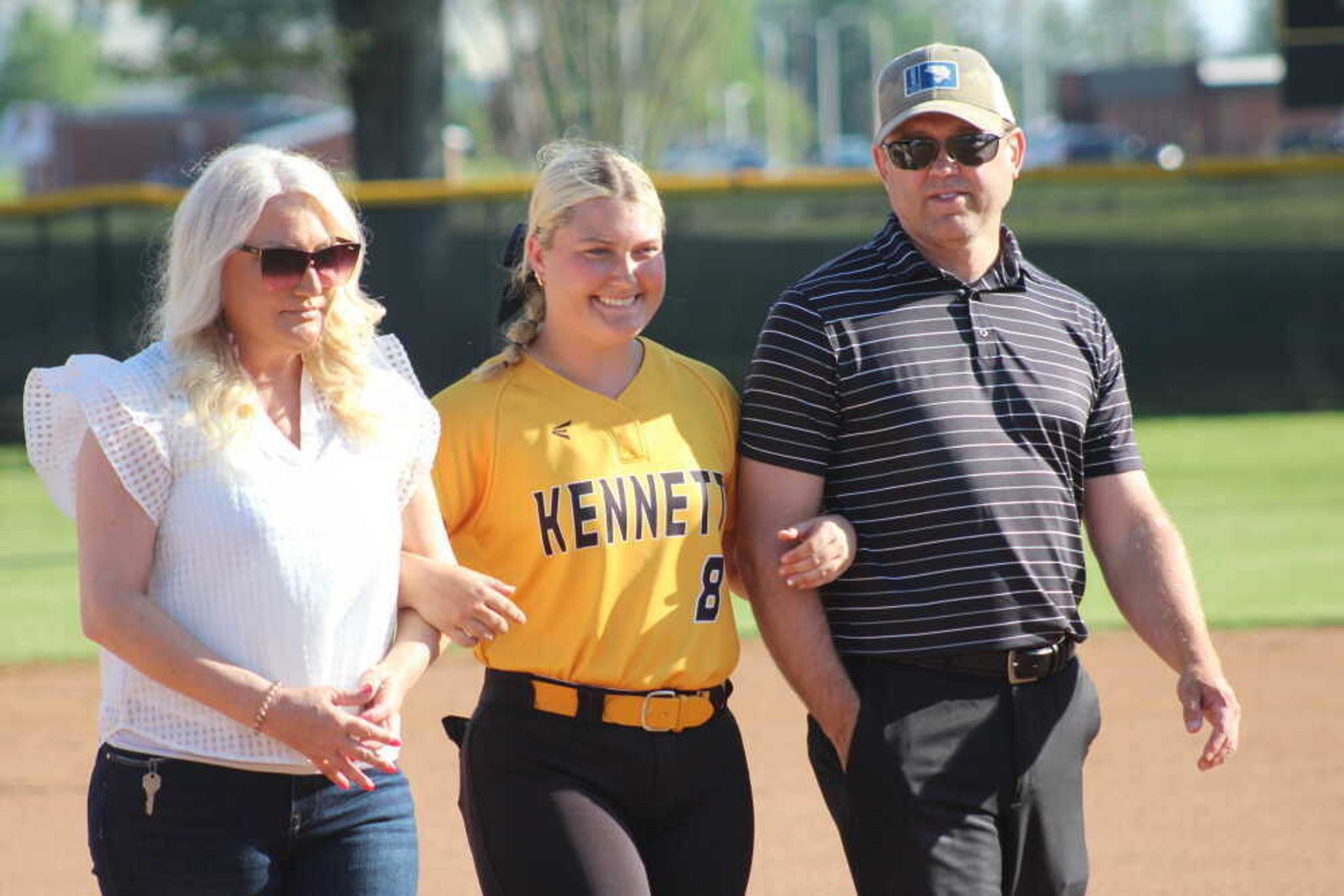 Kennett Lady Indians senior Hadley Wilson is escorted by loved ones on Senior Night at Indian Park. Wison continues her high-school softball career at MSHSAA's Class 2 State Tournament at Springfield.