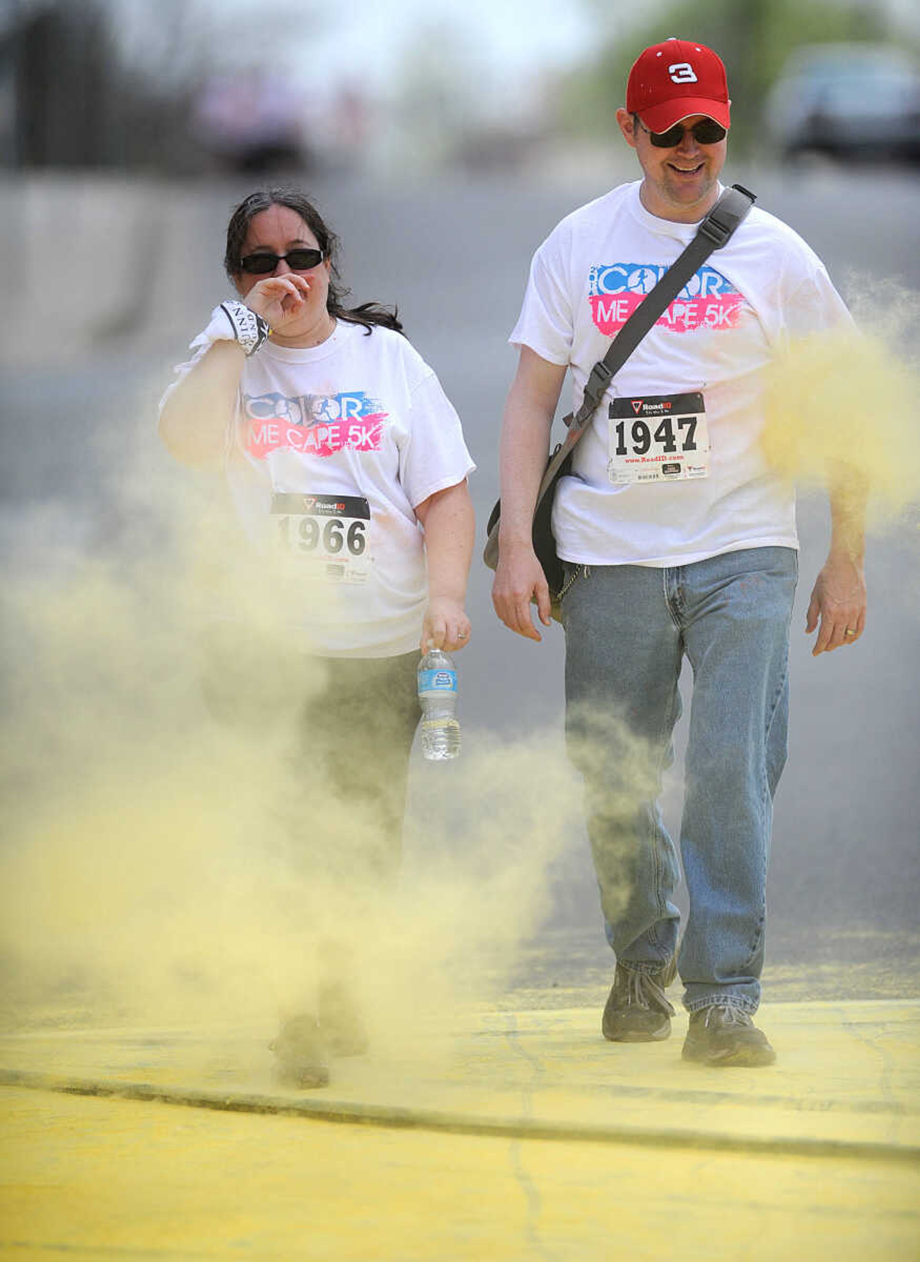 LAURA SIMON ~ lsimon@semissourian.com

Participants in the Color Me Cape 5K are sprayed with yellow powder at the second color station on Frederick Street, Saturday, April 12, 2014, in Cape Girardeau.