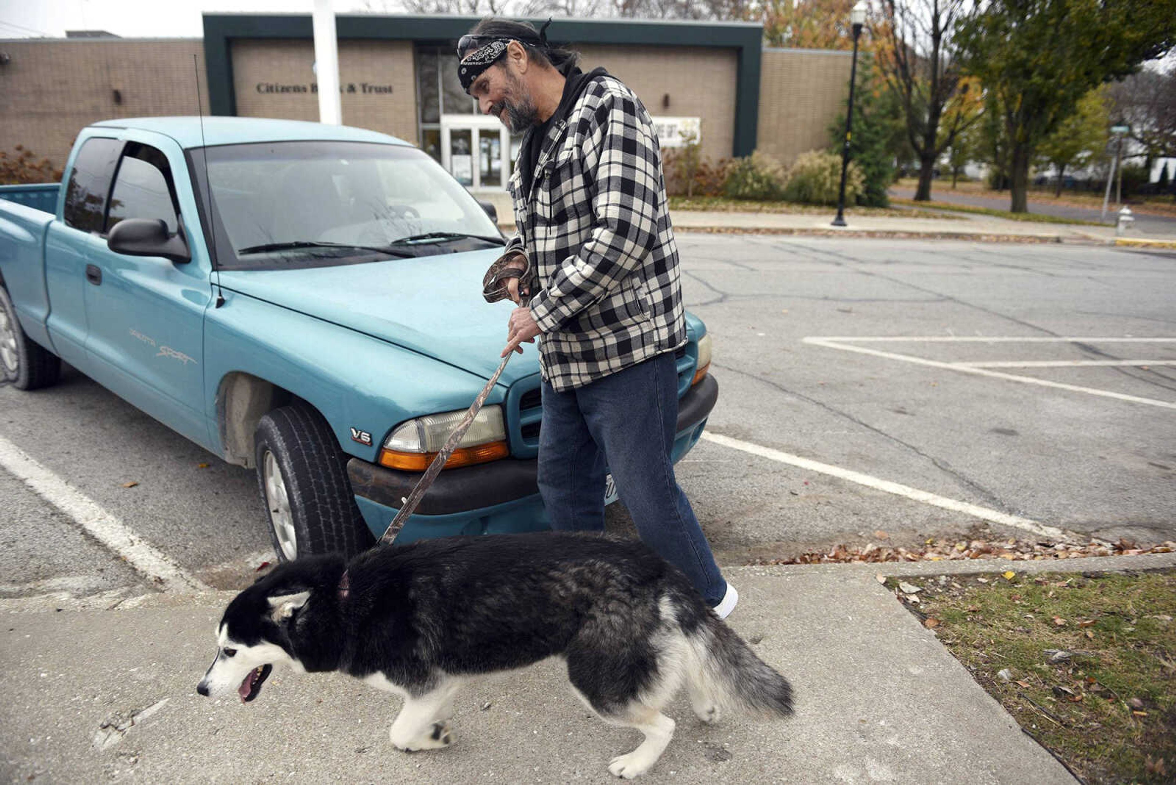 Denny Sercu walks with his dog Aspen on Nov. 17 near his home in Boonville, Missouri. Sercu has battled opioid and heroin addiction for decades. He's been clean for two years.